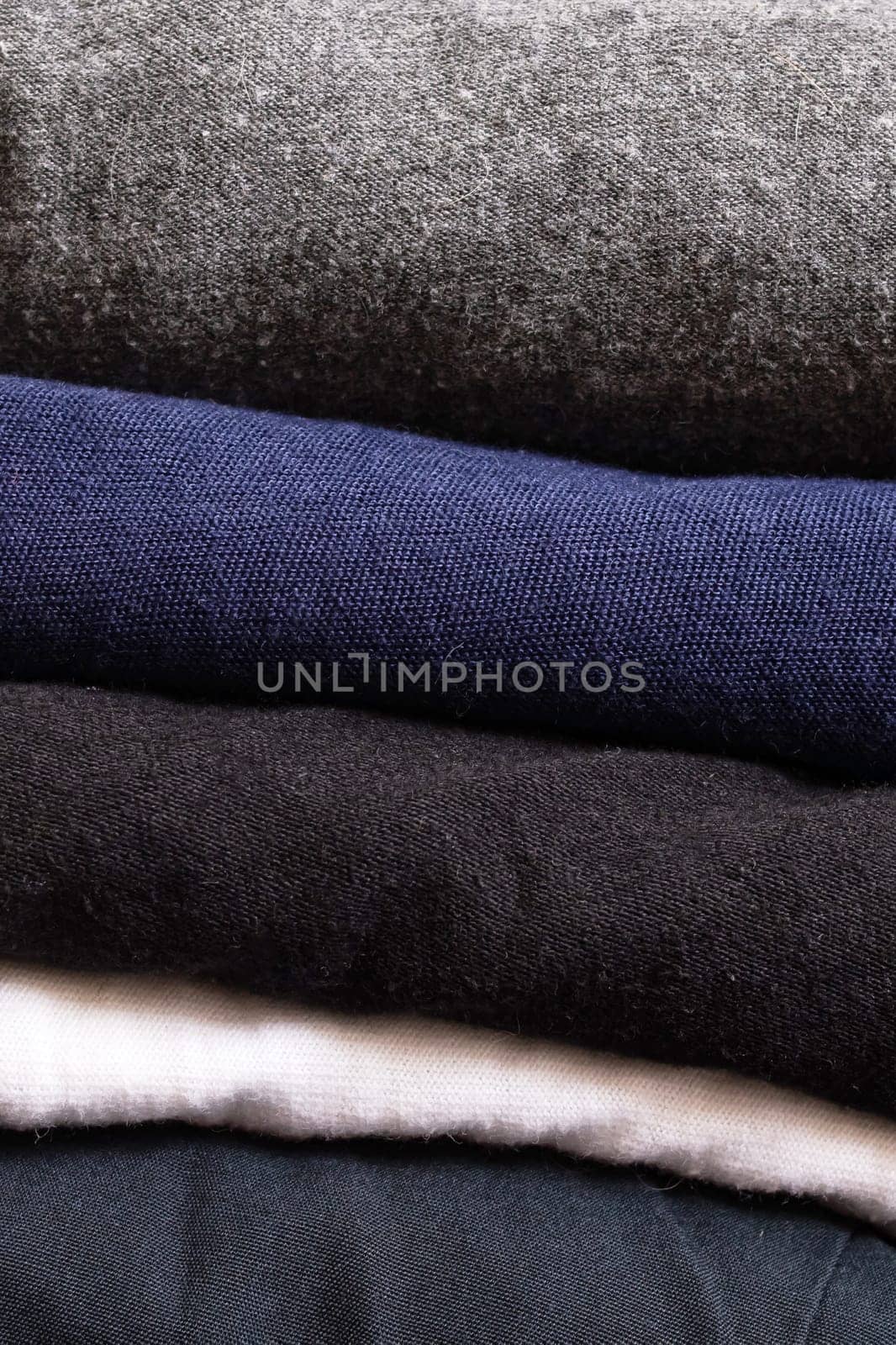 Stack of clothes on a wooden background close up