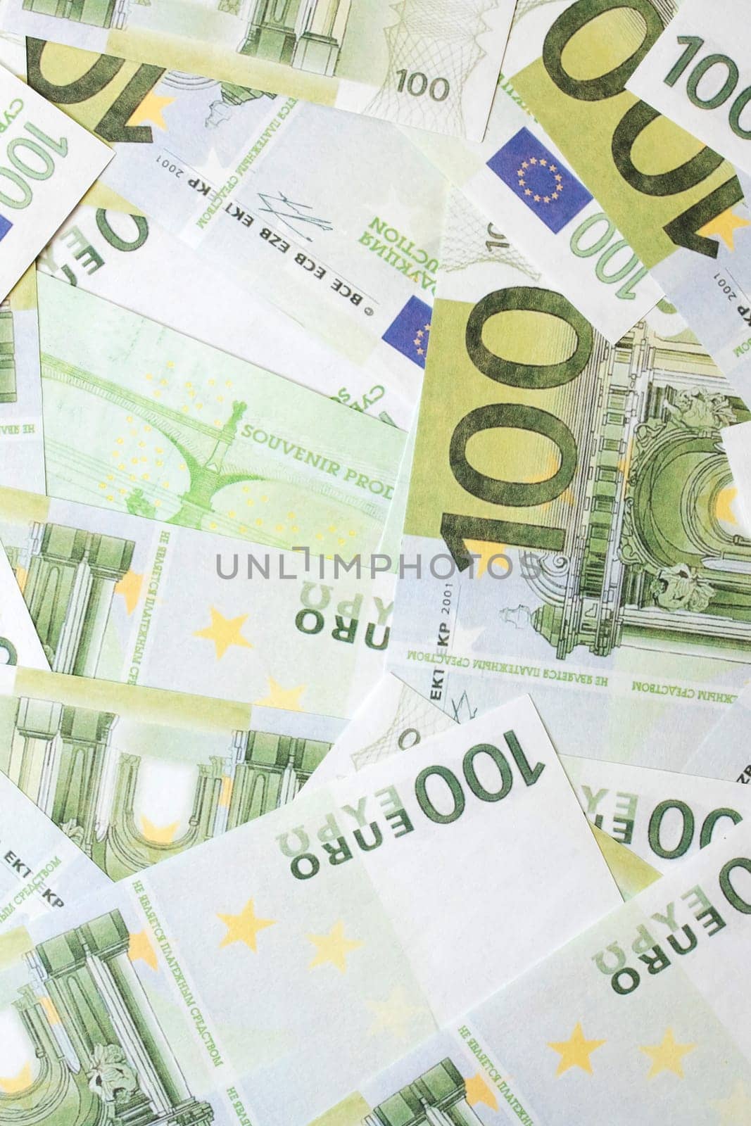 Scattered banknotes of one hundred euros close up, abstract background