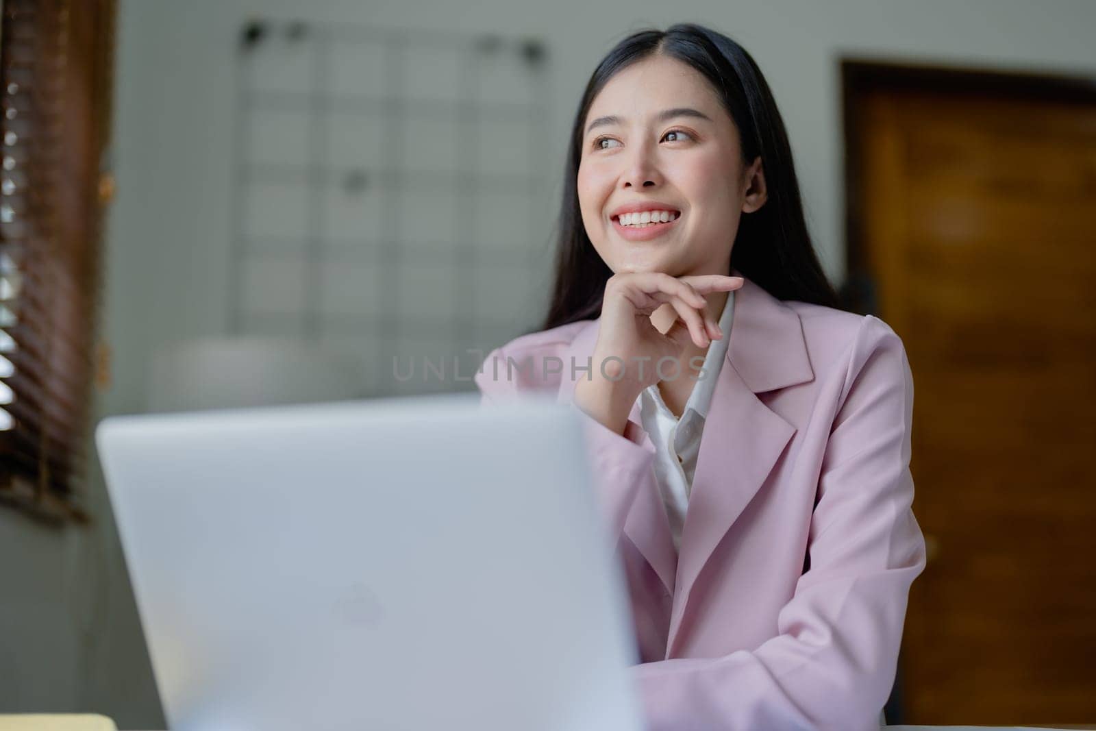 Excited businesswoman using computer laptop while in office, business concepts