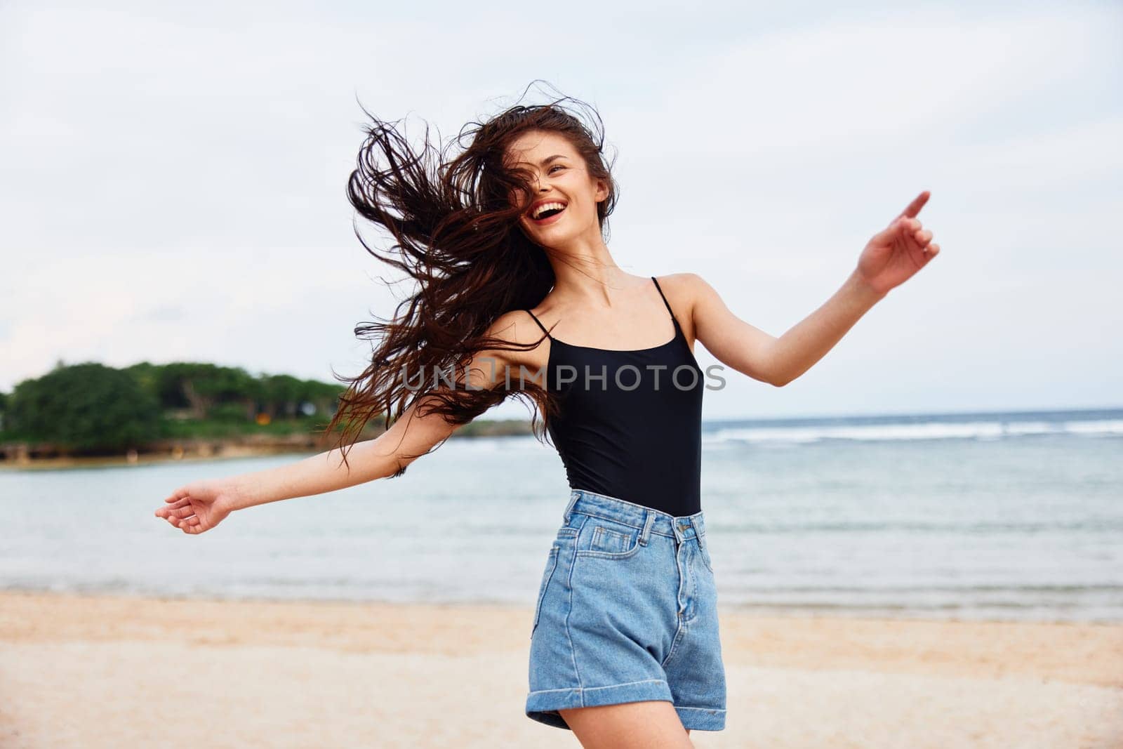 woman carefree happy freedom beach female water summer tan travel sea sunset lifestyle young sunrise beauty wave active running smiling smile