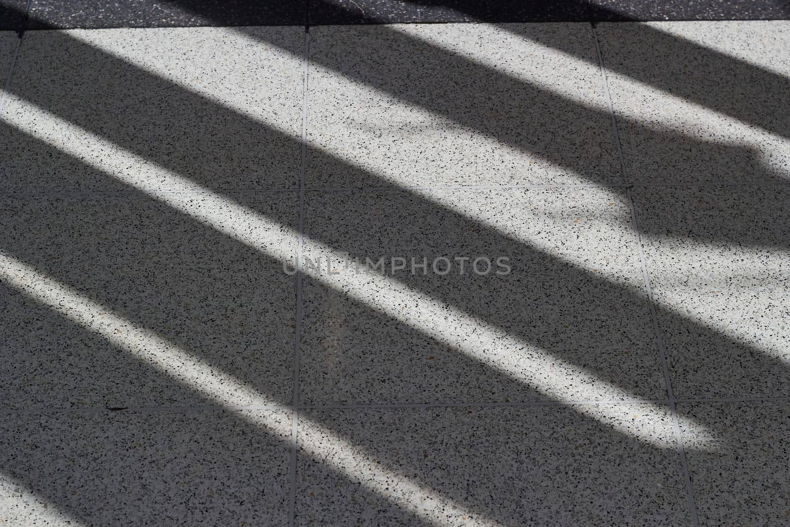 Abstract background diagonal shadows on the floor. White and black image.