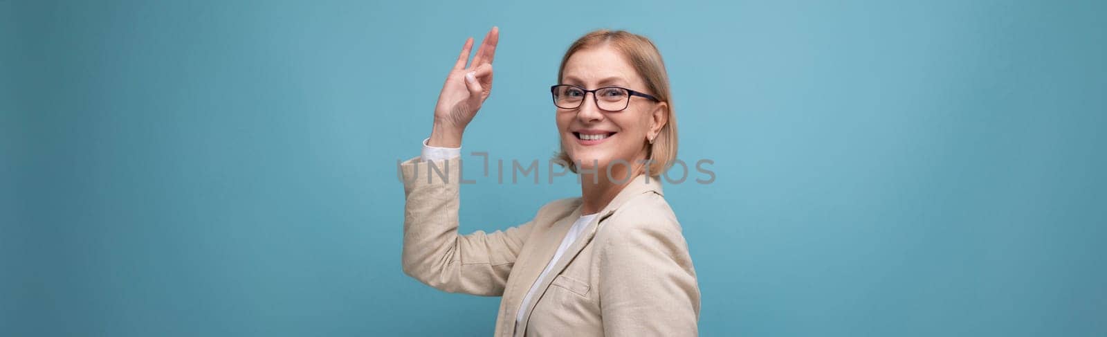 wide horizontal photo of a confident mature business lady in a classic jacket on a bright background with copy space.