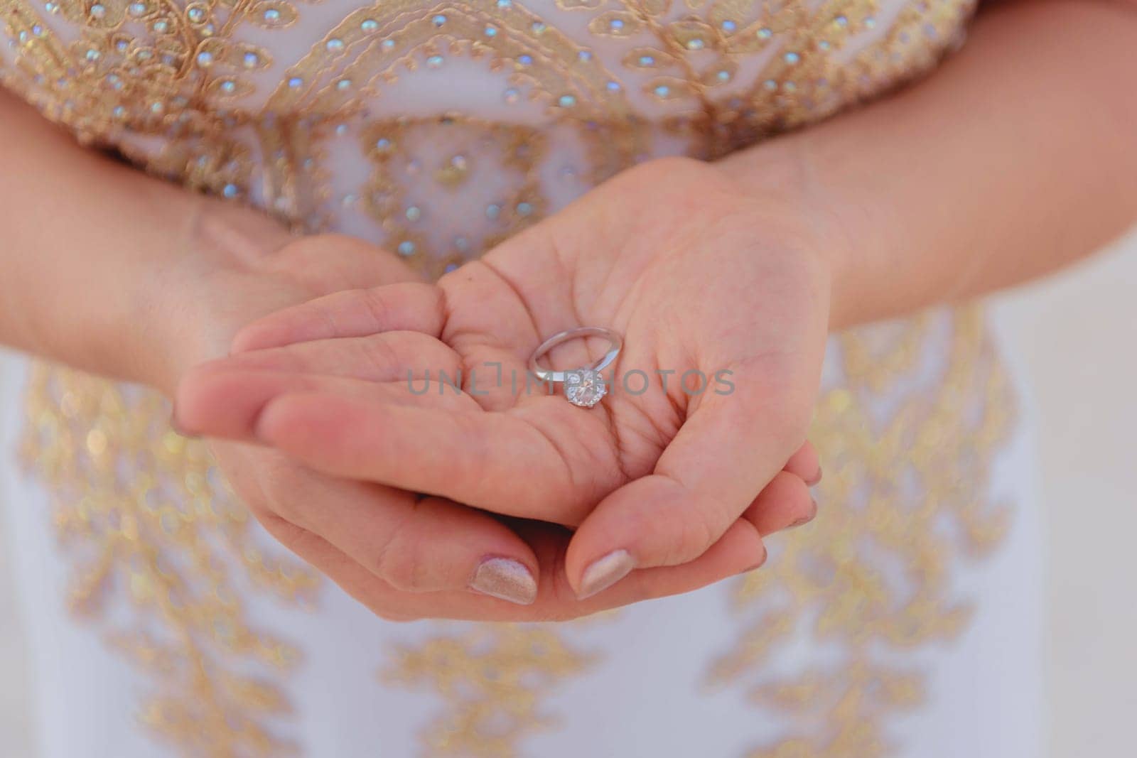 Wedding rings on the palm close-up with blurred background.