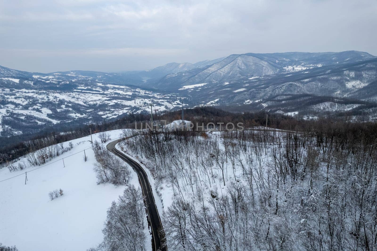 Aerial view of snowy mountain winter white landscape Vezzolacca , Emilia Romagna, Italy