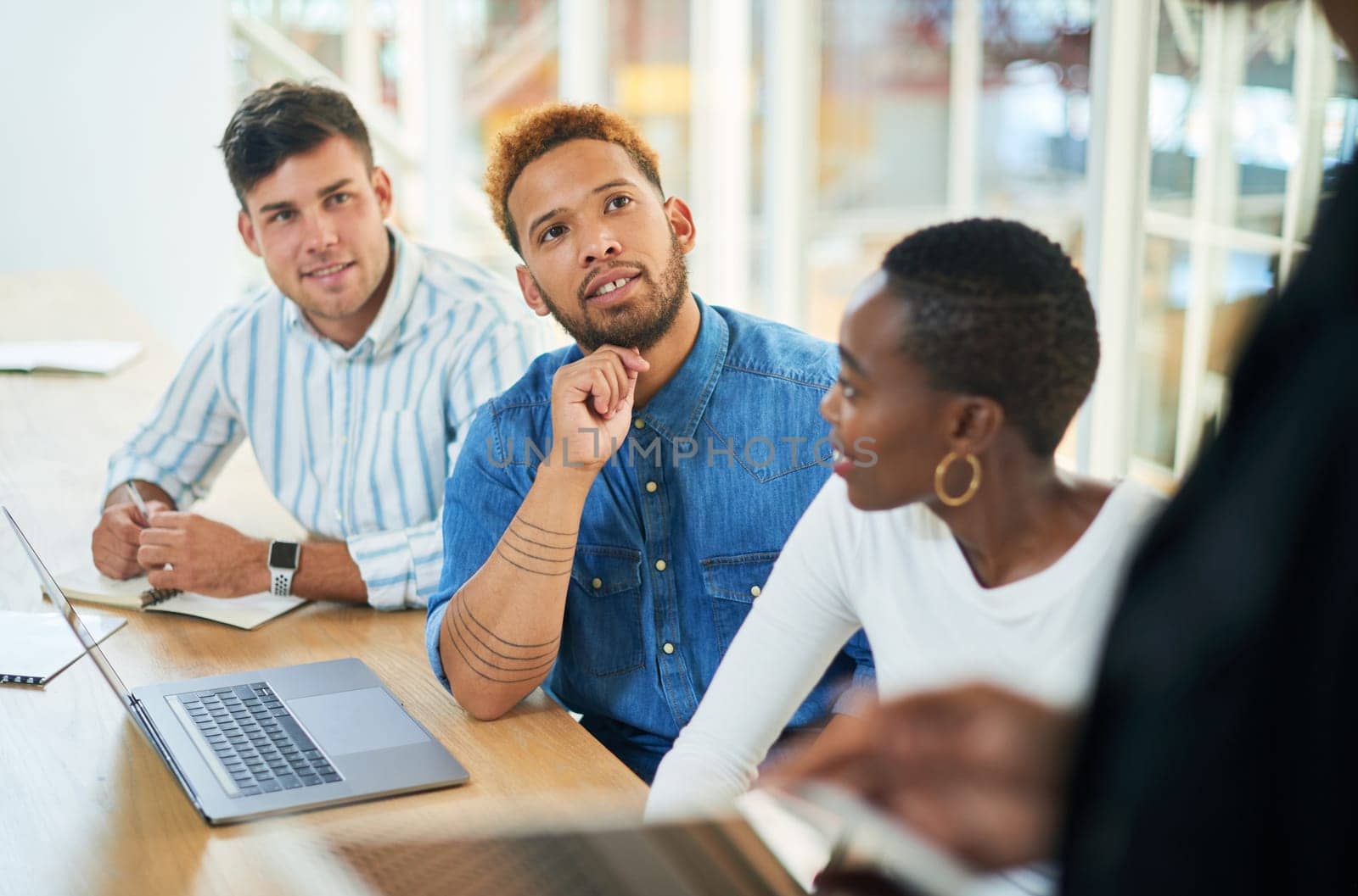 Stay open to new information. a group of young businesspeople having a meeting in a modern office. by YuriArcurs