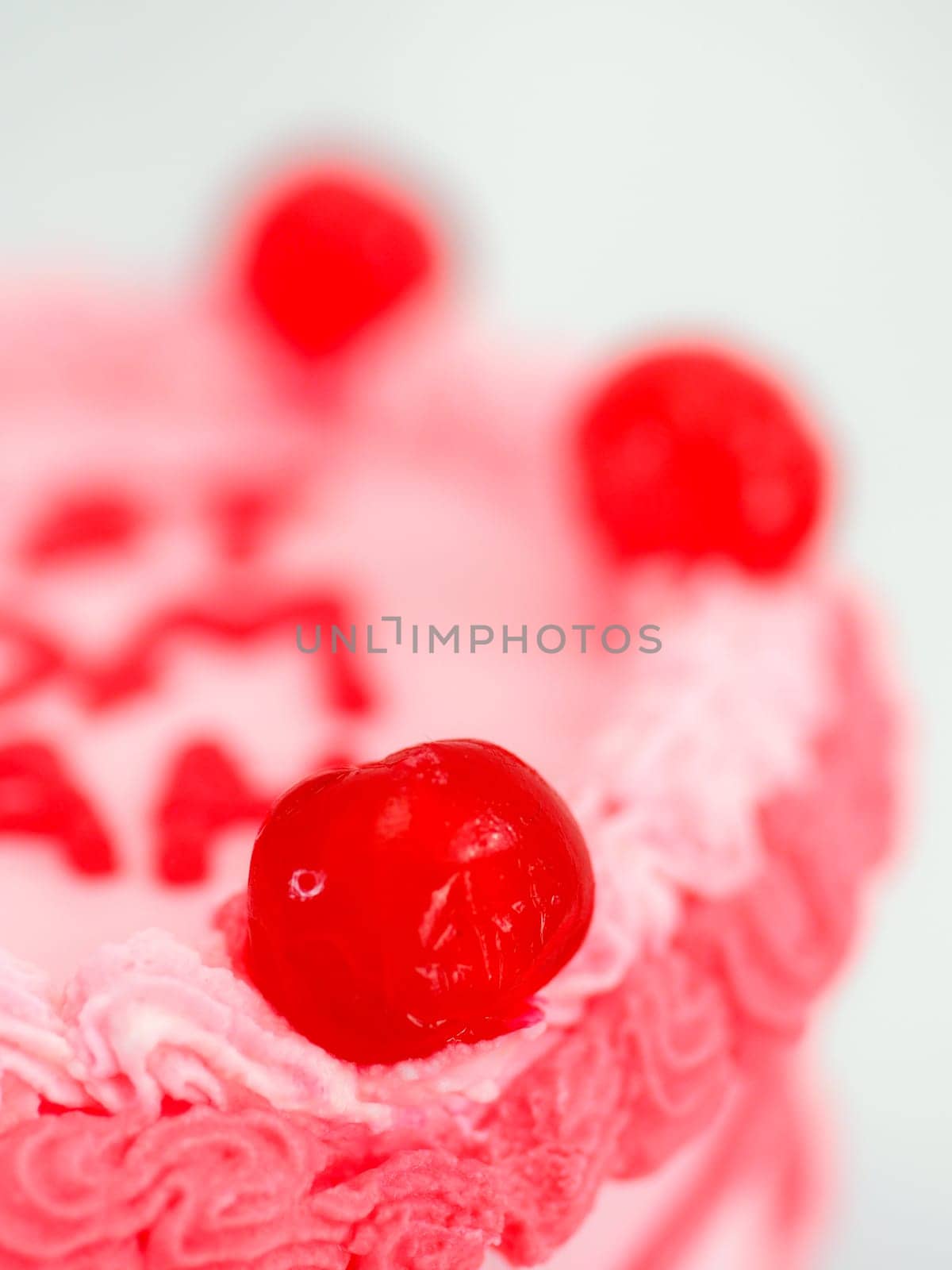 frosted pink red cake for mothers day celebration with funny text topping best mom evah on white studio background