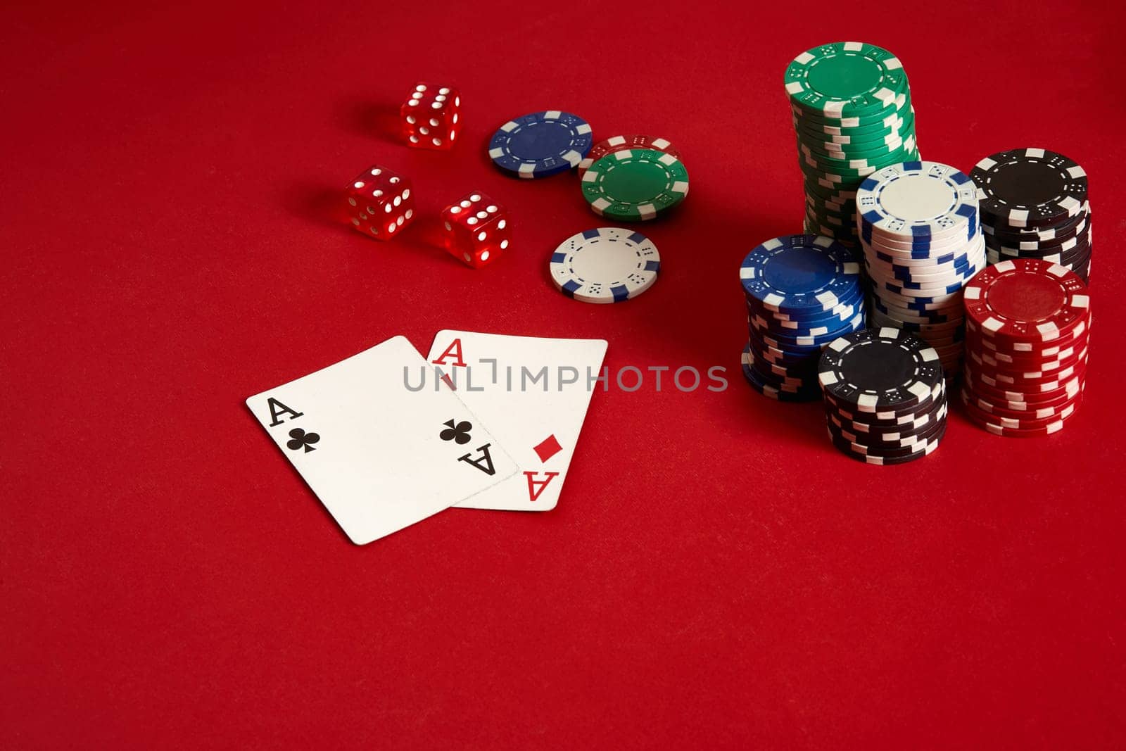 Poker chips and aces on red background. Group of different poker chips. Casino background. Copy space. Still life. One Pair