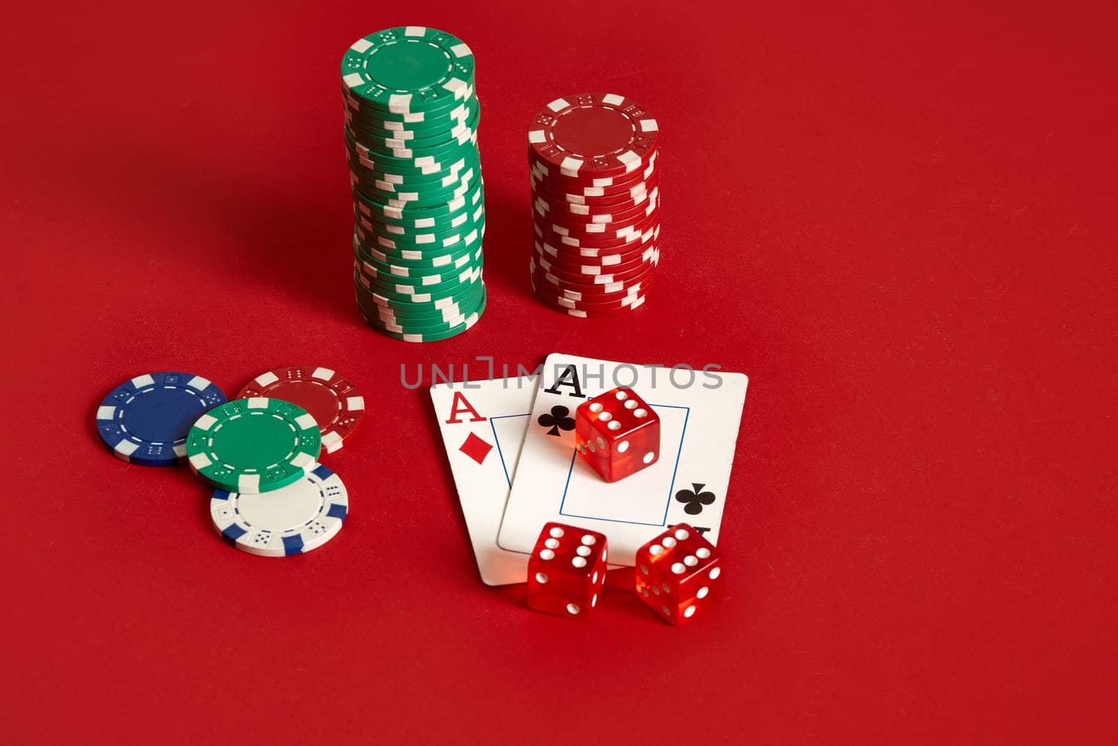 Poker chips and aces on red background. Group of different poker chips. Casino background. Copy space. Still life. One Pair
