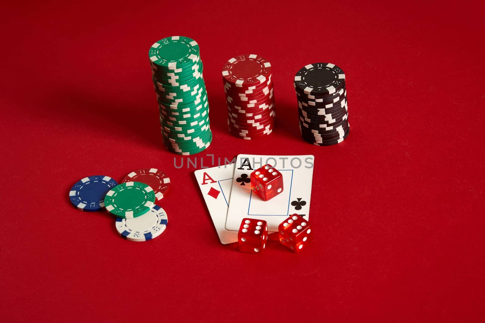Poker chips and aces on red background. Group of different poker chips. Casino background. Copy space. Still life. One Pair