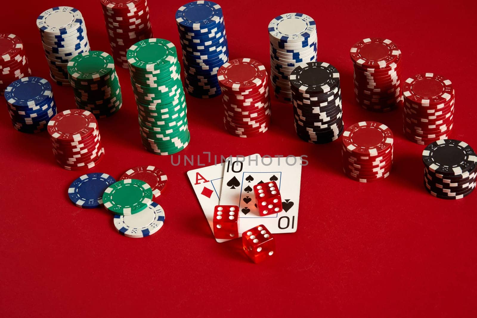 Poker cards and gambling chips on red background. Top view. Copy space. Still life. Flat lay. Cards - Ace and Ten