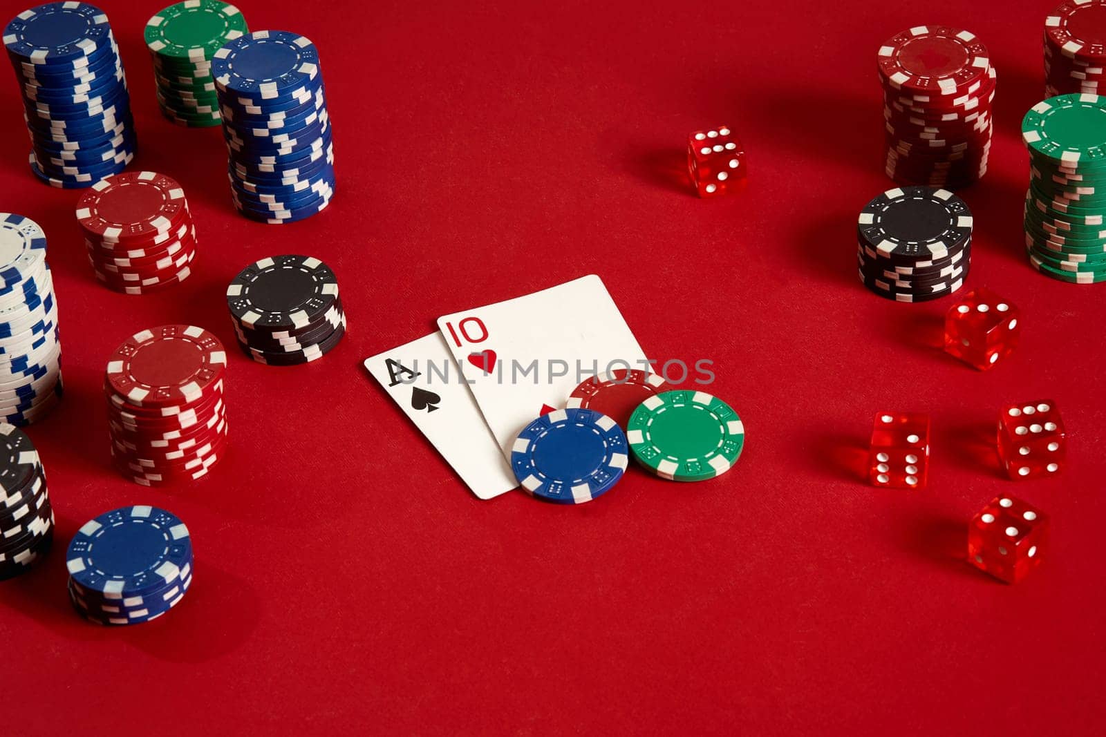 Poker cards and gambling chips on red background. Top view. Copy space. Still life. Flat lay. Cards - Ace and Ten