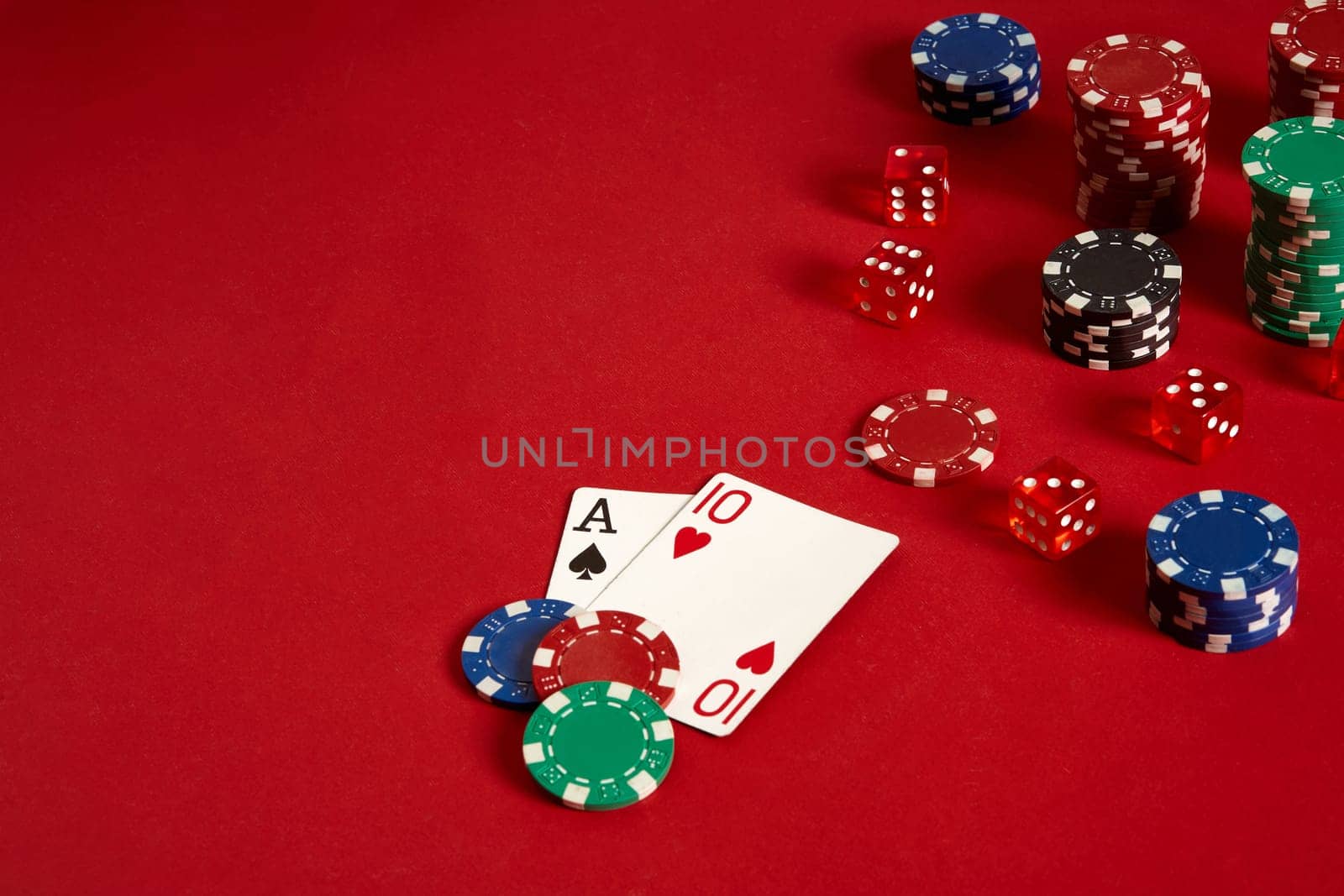 Poker cards and gambling chips on red background. Top view. Copy space. Still life. Flat lay. Cards - Ace and Ten
