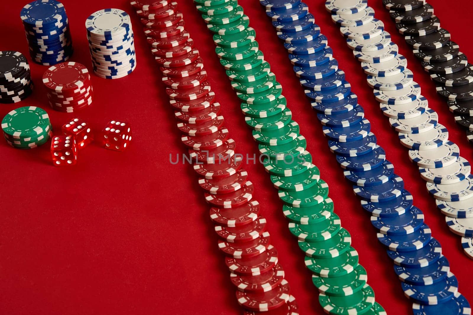 Stack of poker chips on red background at casino. Top view. Copy space. Still life. Flat lay