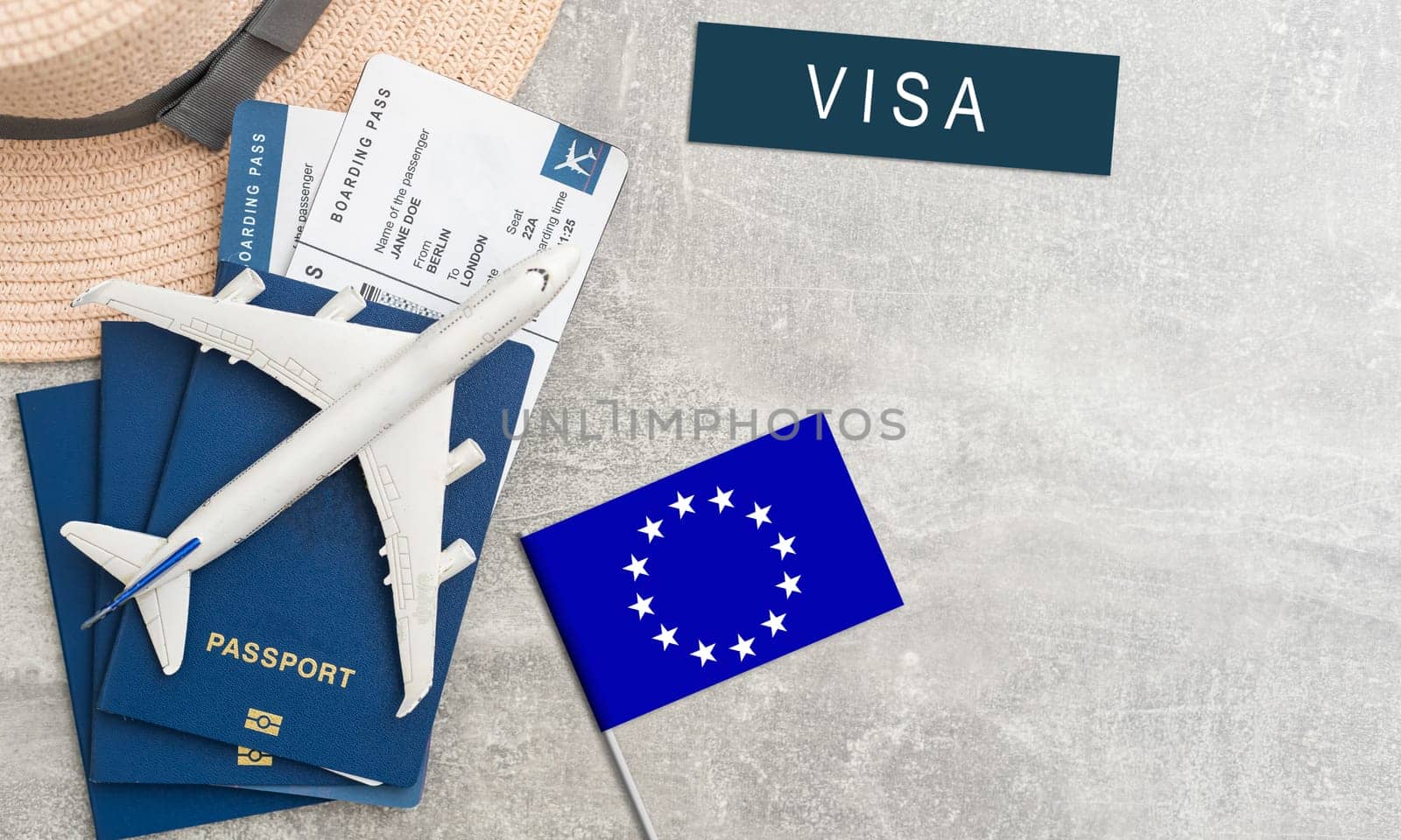 Flag of European Union with passport and toy airplane on wooden background. Flight travel concept by Andelov13