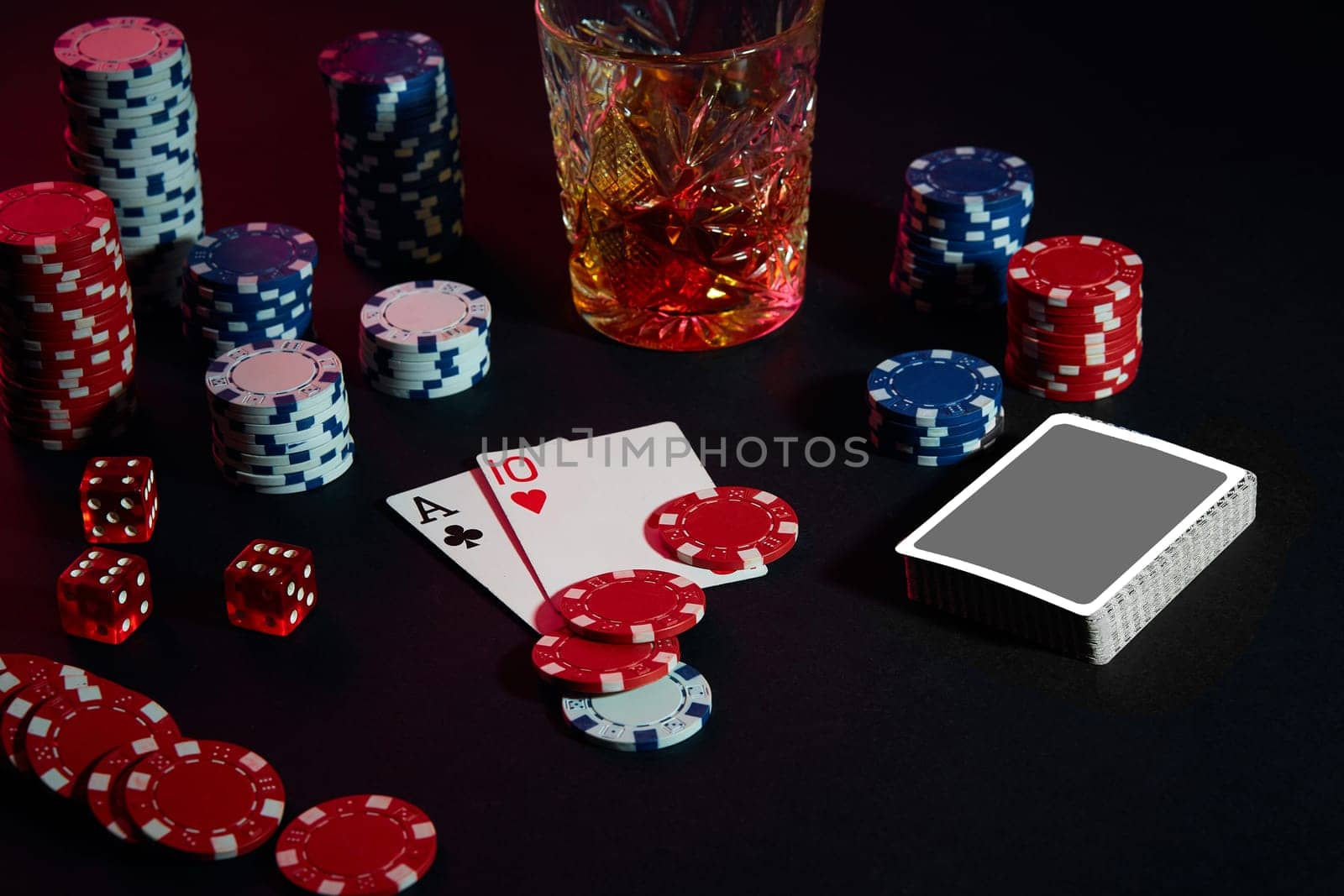 Cards of poker player. On the table are chips and a glass of cocktail with whiskey. Still life. The concept of gambling. Poker Online. Combination of cards