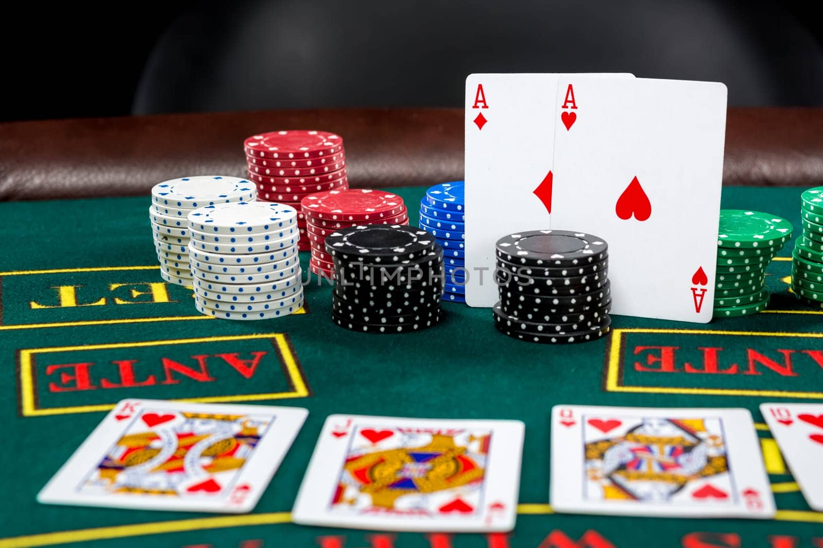 Poker play. Chips and cards on the green table