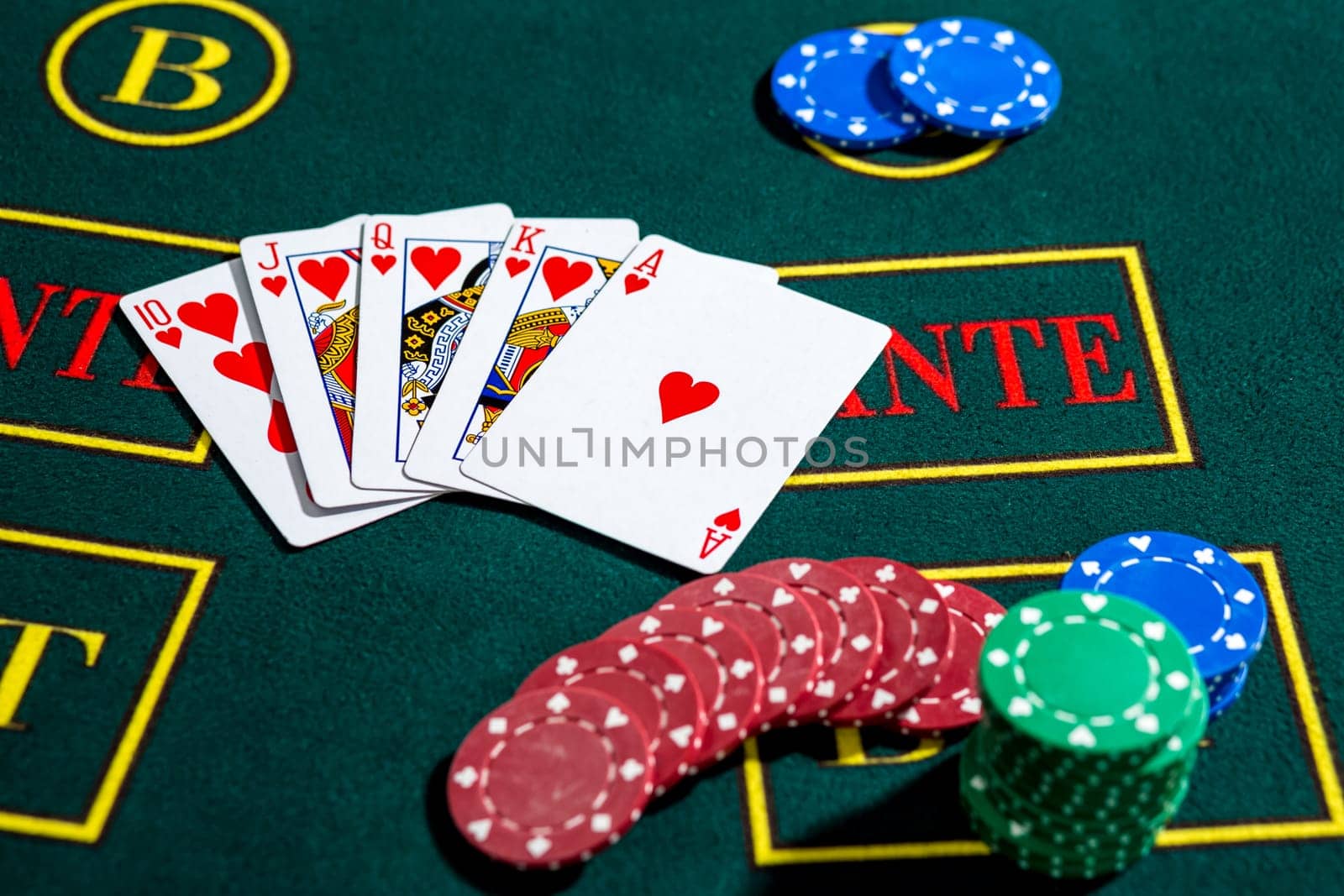 Poker play. Chips and cards on the green table