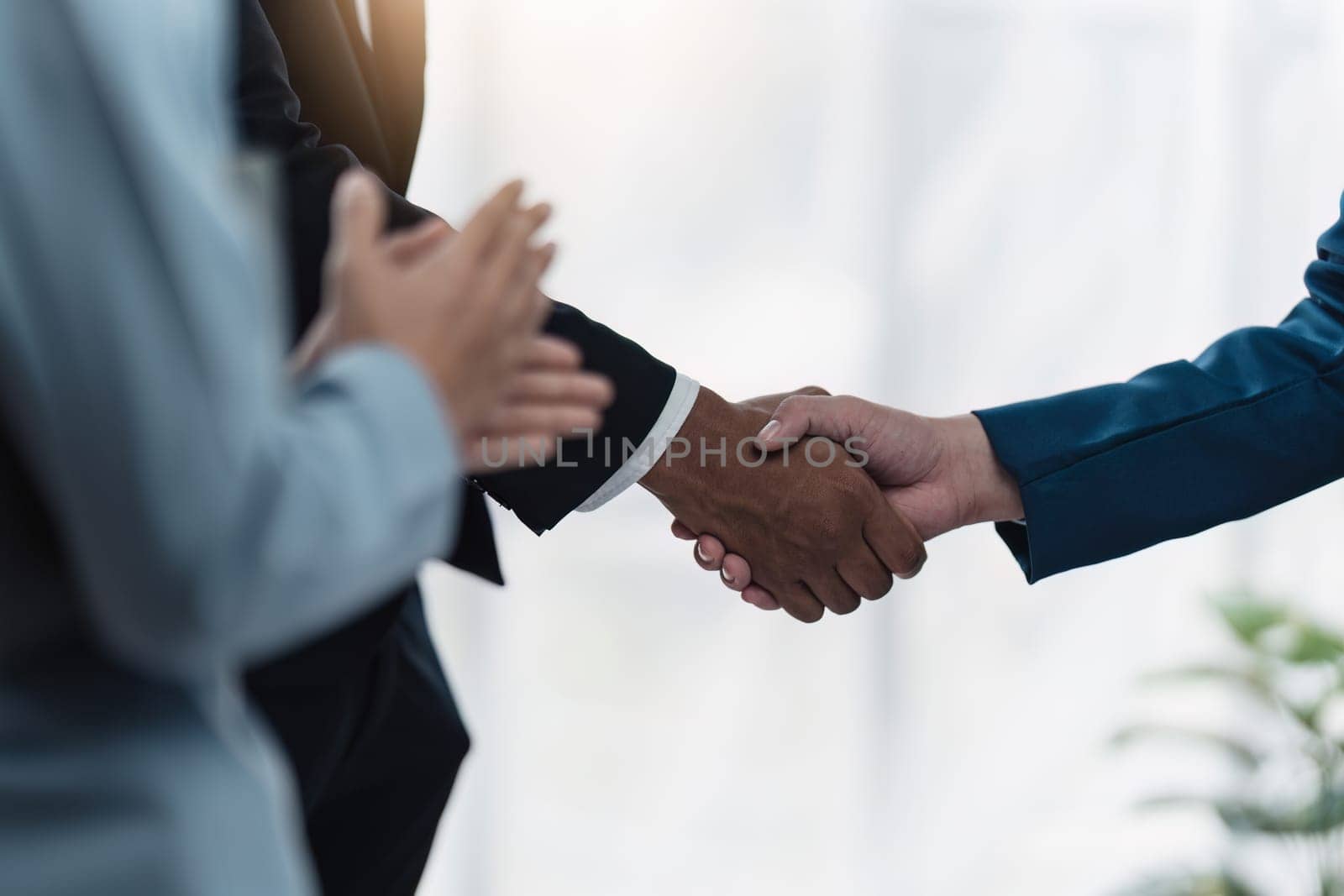 Business partnership meeting concept. Image business people handshake. Successful businessmen handshaking after good deal. Group support concept by itchaznong