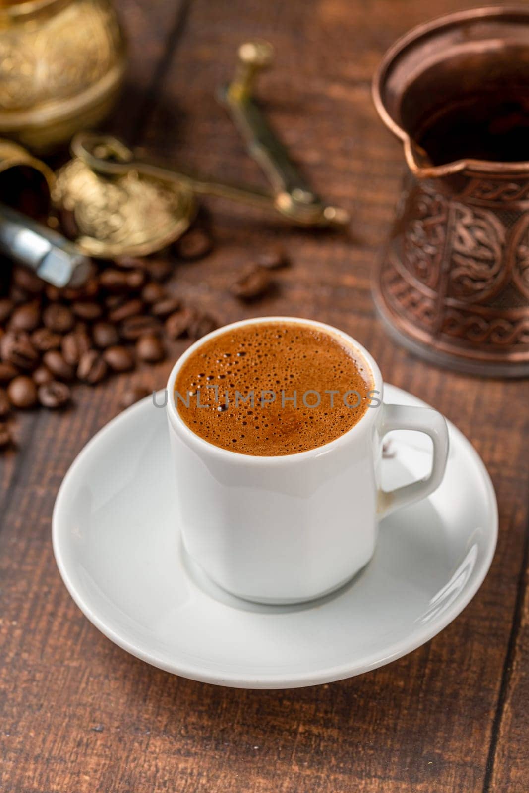 Turkish coffee in classic coffee cup with water and Turkish delight on wooden table