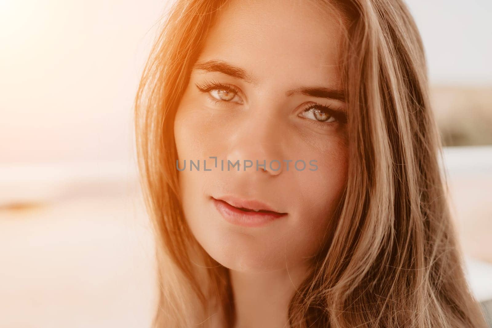 Happy woman portrait in cafe. Boho chic fashion style. Outdoor photo of young happy woman with long hair, sunny weather outdoors sitting in modern cafe