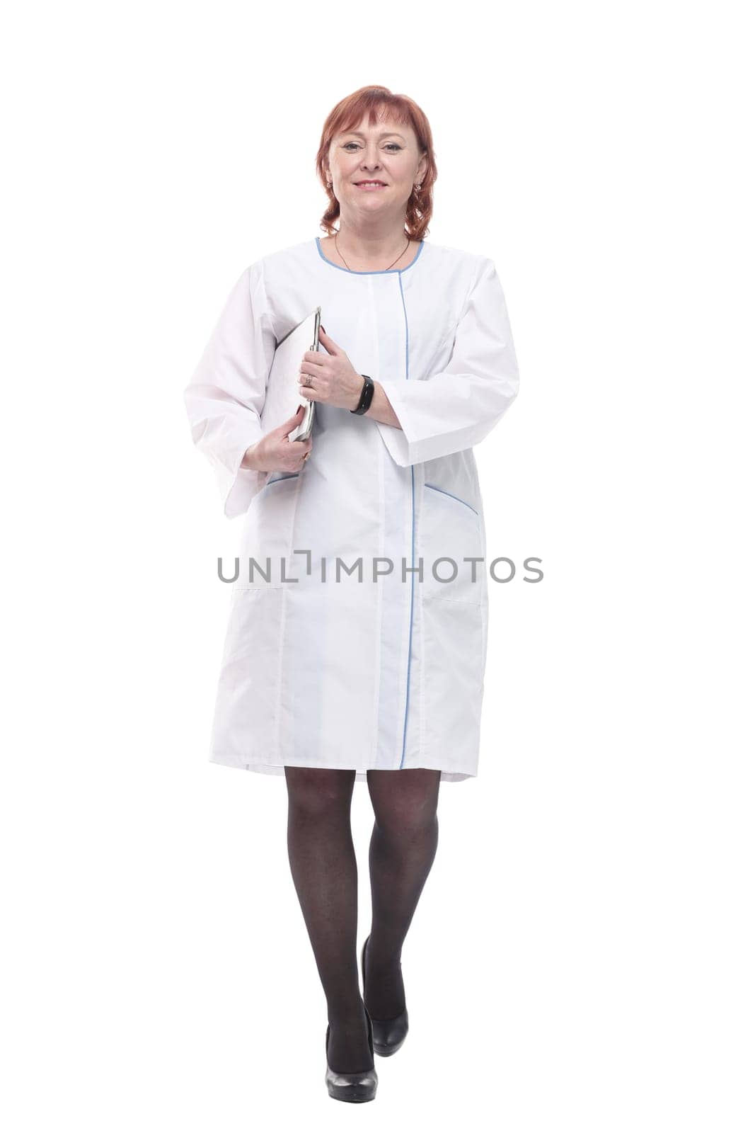 in full growth. competent female doctor with clipboard striding forward . isolated on a white background.