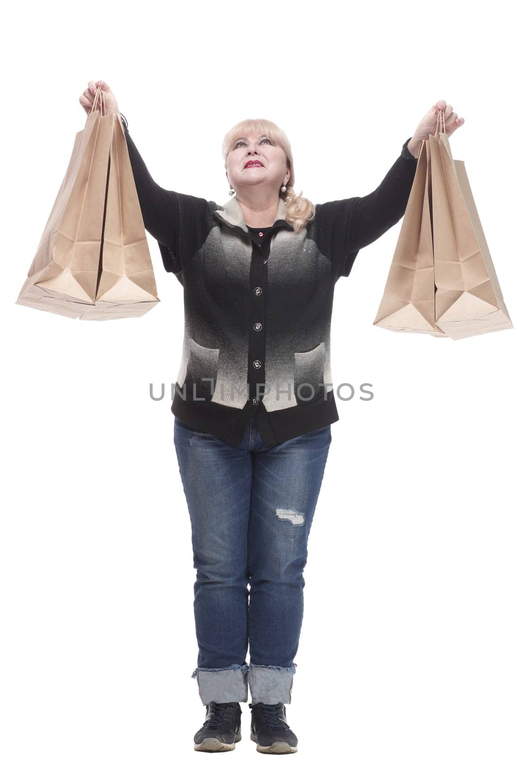 full-length. casual woman in jeans with shopping bags. isolated on a white background.