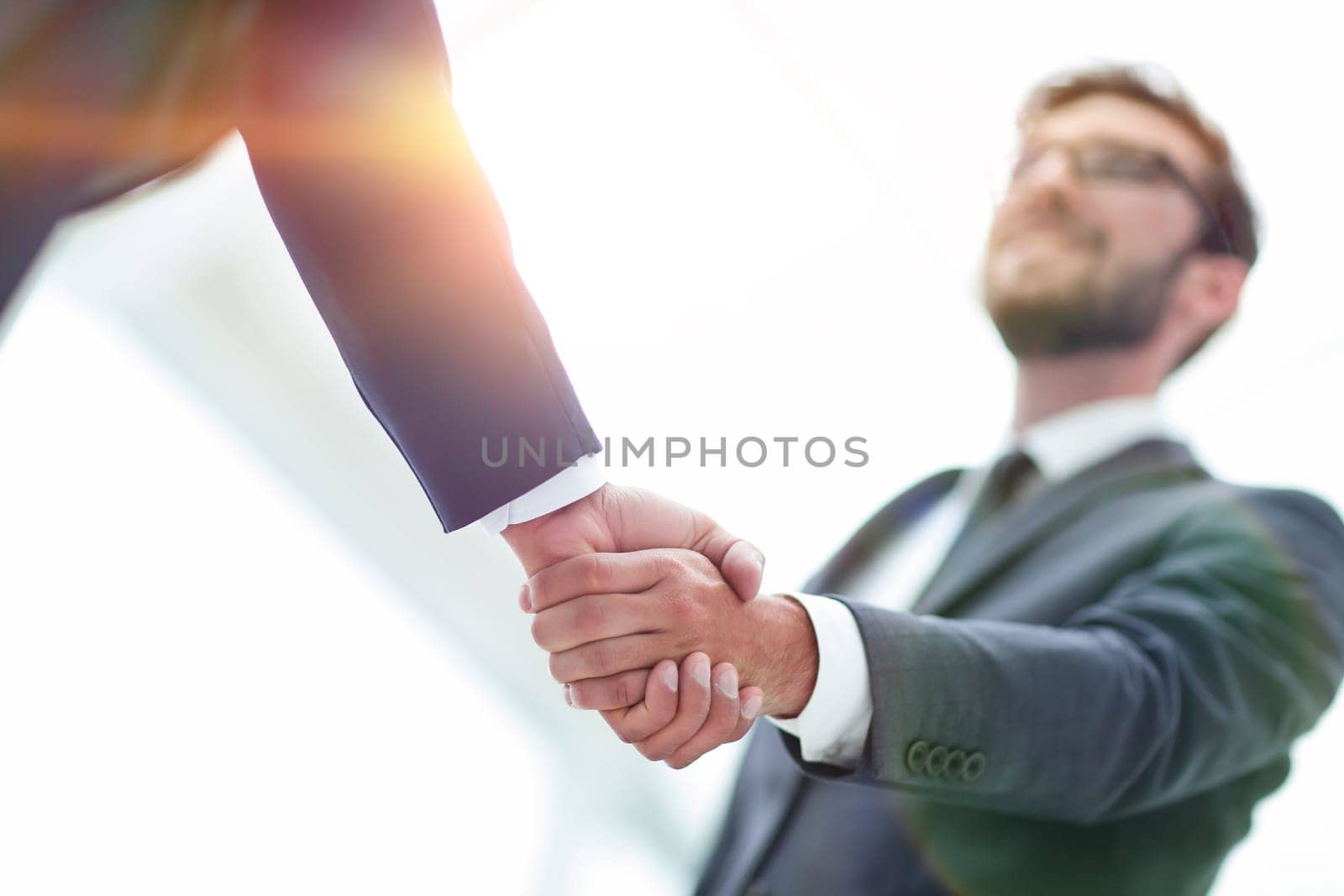 Close-up of two men hands shaking after signing contract