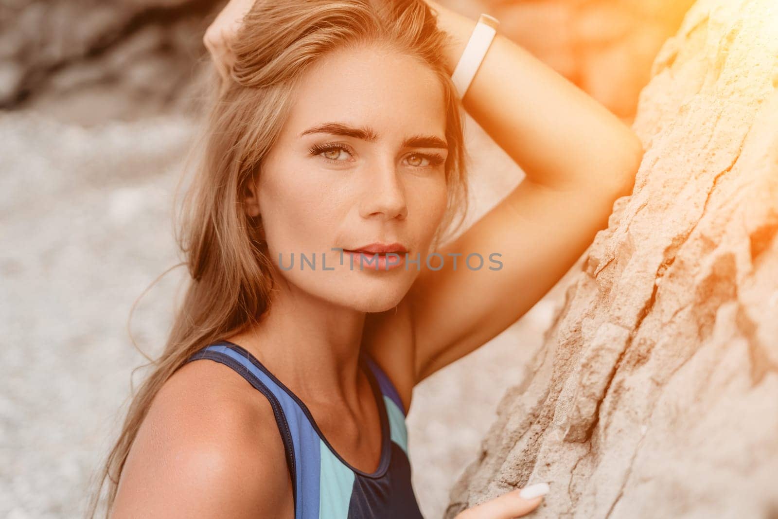 Woman summer travel sea. Happy tourist in blue bikini enjoy taking picture outdoors for memories. Woman traveler posing on the beach surrounded by volcanic mountains, sharing travel adventure journey by panophotograph