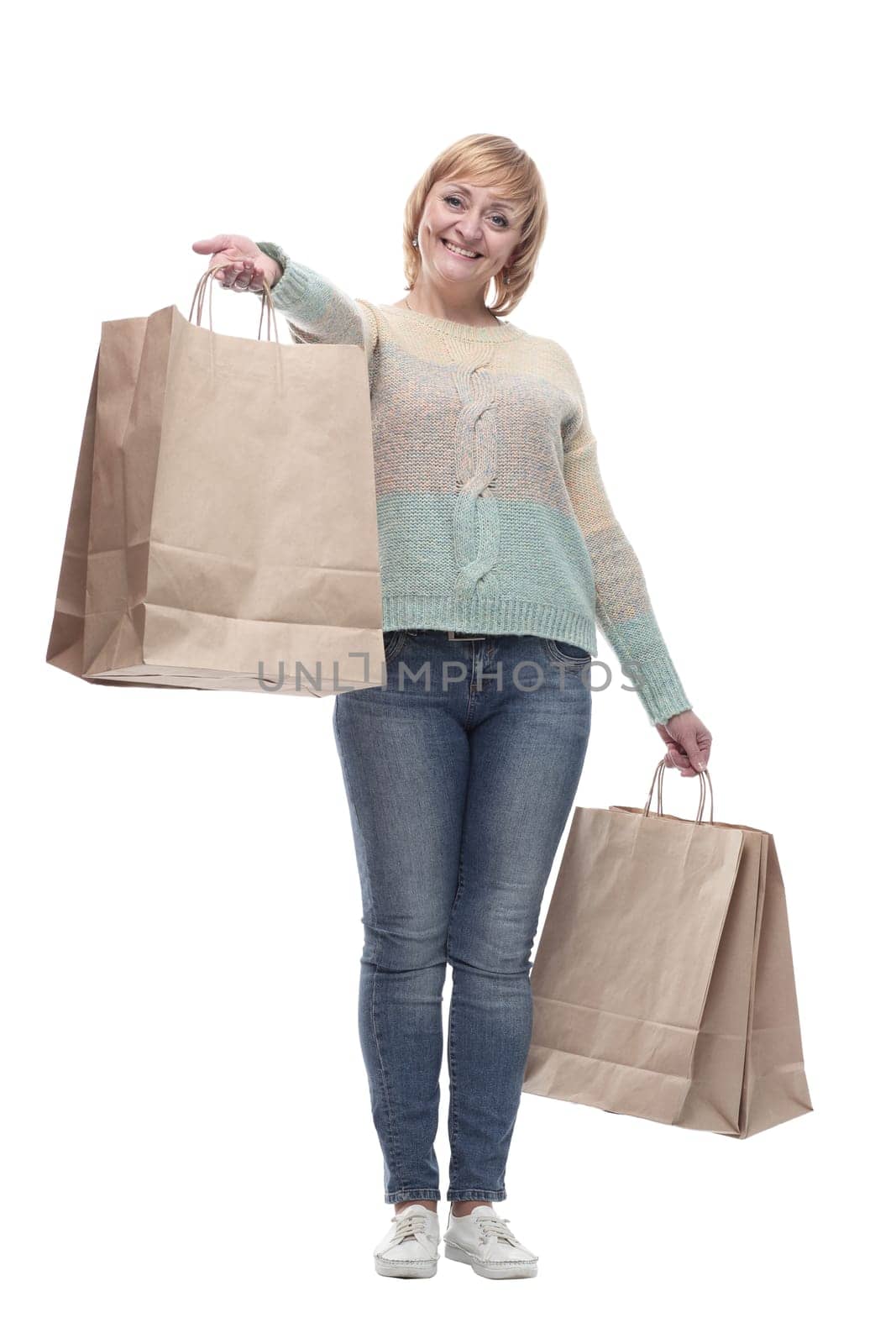 in full growth. attractive casual woman with shopping bags . isolated on a white background.