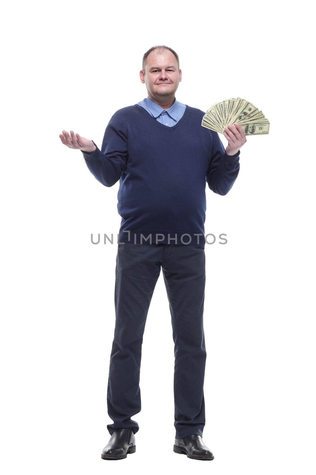 in full growth.Mature man showing cash bills . isolated on a white background.