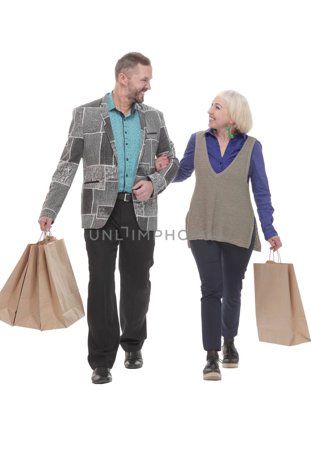 in full growth. happy married couple with shopping bags. isolated on a white background.