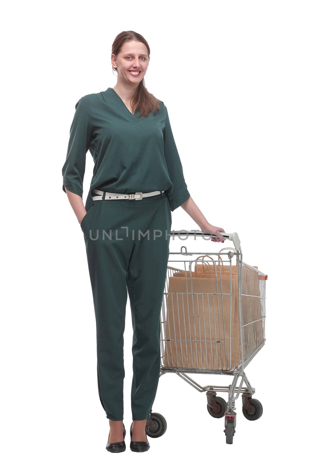 Full length portrait of a woman pushing a shopping trolley isolated on white background