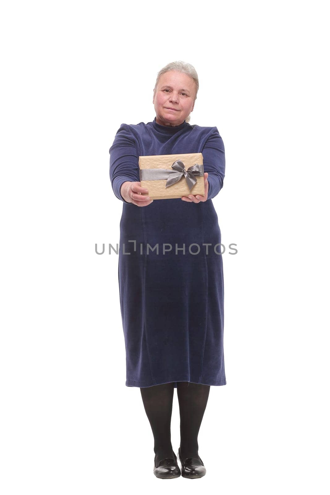 Mature blonde smiling and looking at camera holding gift on white background