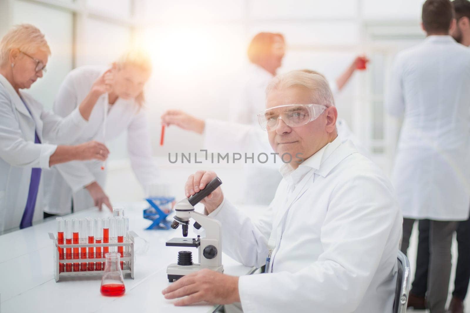 smiling scientist at the workplace in the laboratory. by asdf