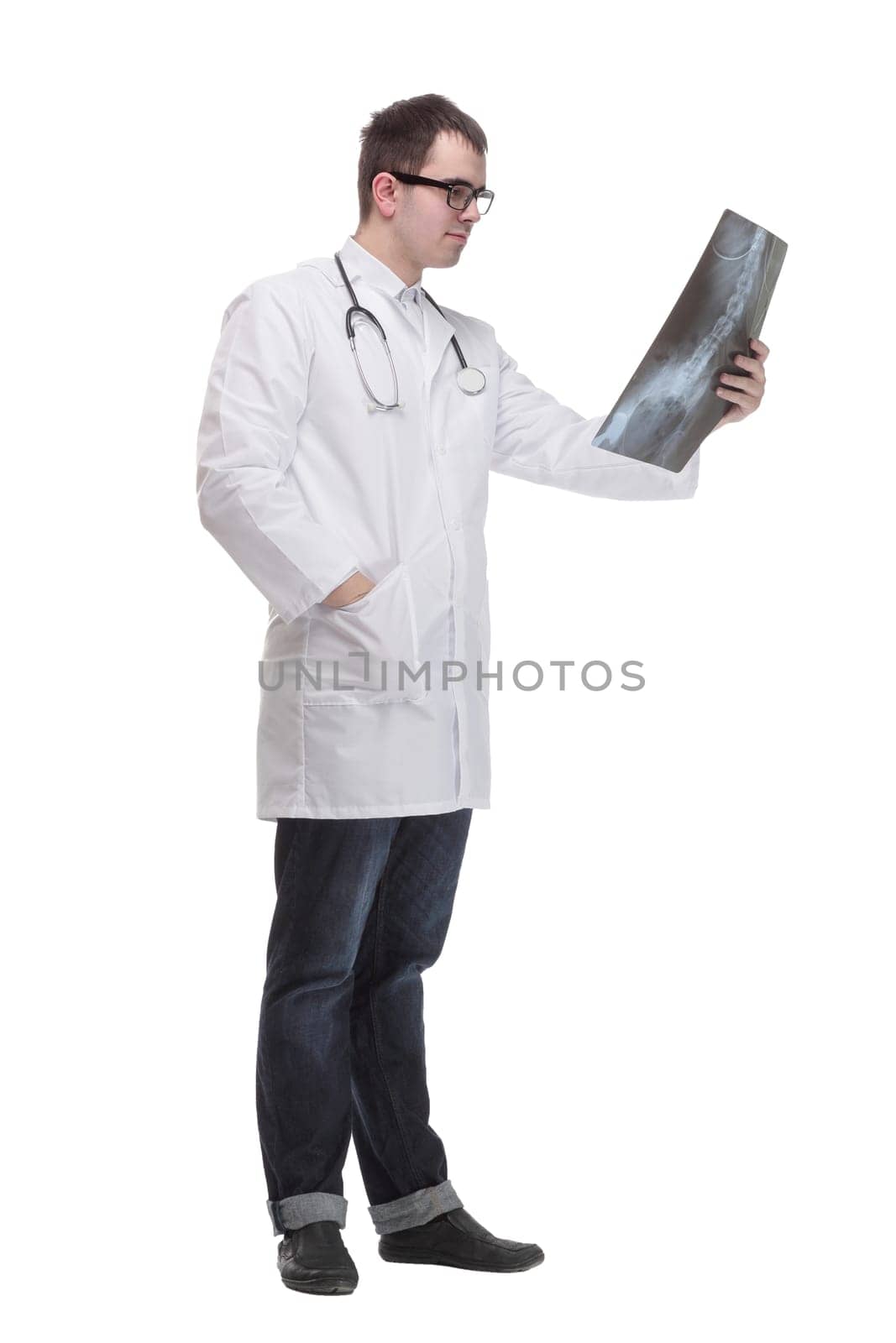 Front view of hospital doctor holding patient's x-ray film and lookind at it
