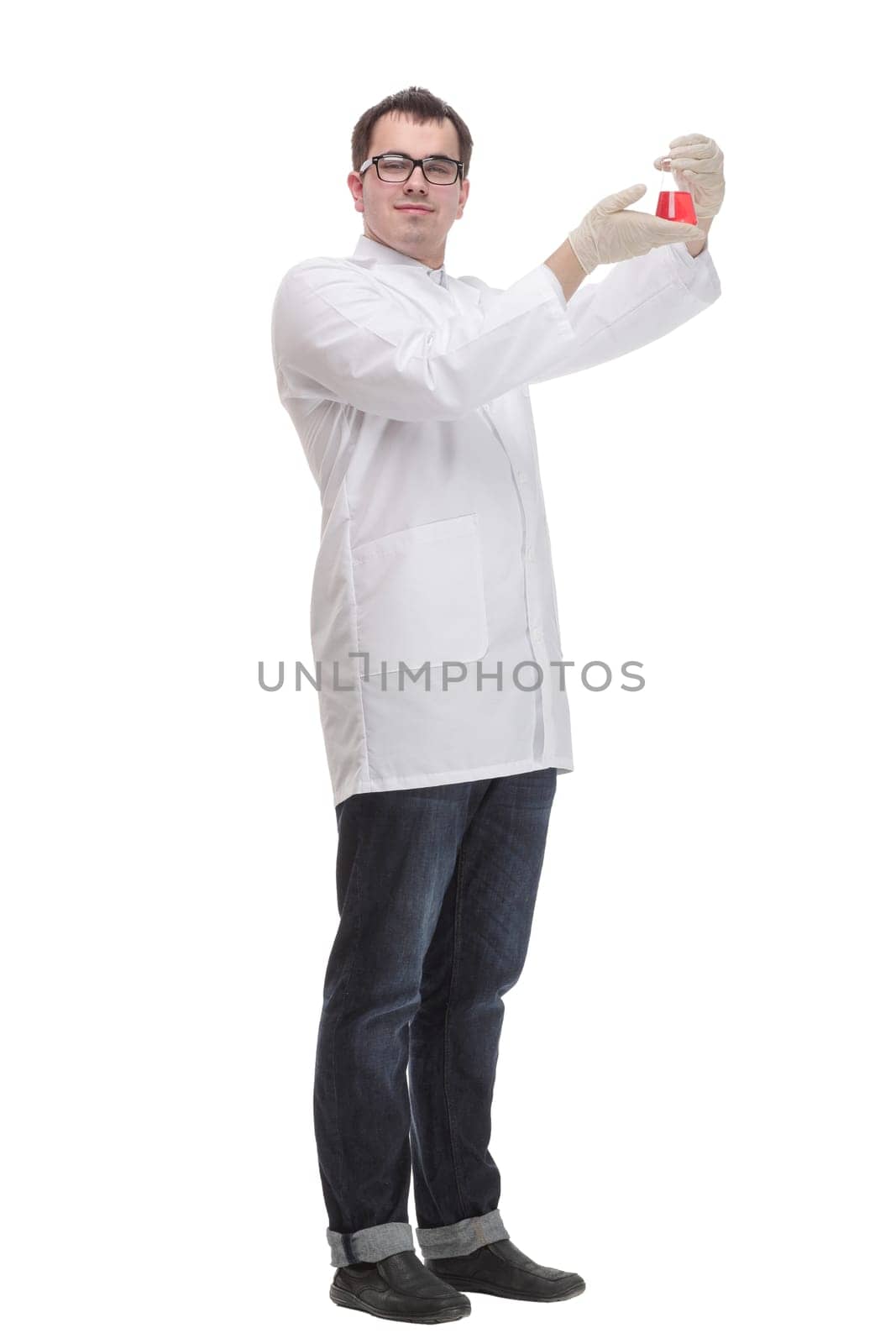 Confident man doctor wearing unifrom and glasses standing isolated over white background, holding beaker