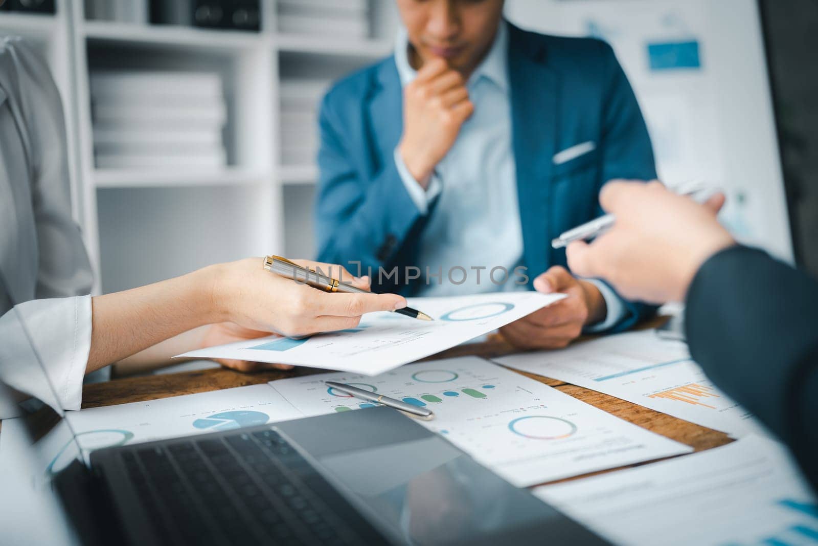 Asian business advisor meeting to analyze and discuss the situation on the financial report in the meeting room.Investment Consultant, Financial , teamwork ,brainstorming ,startup and accounting by Manastrong