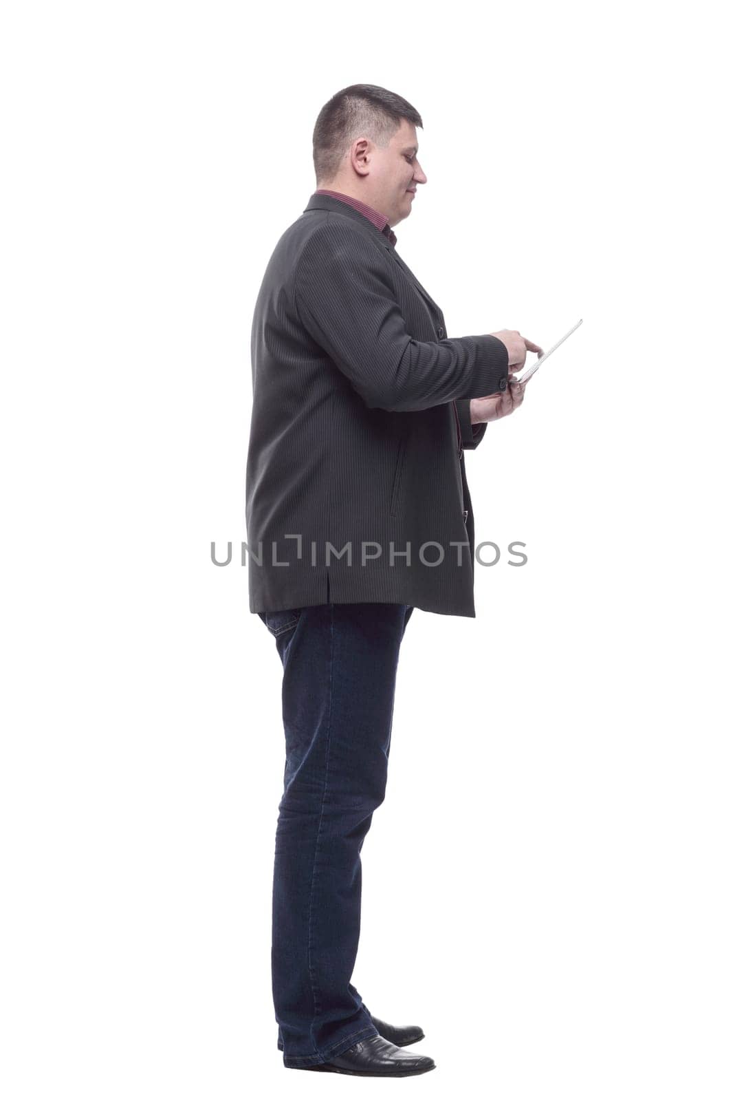 side view. Mature business man with a digital tablet. isolated on a white background.