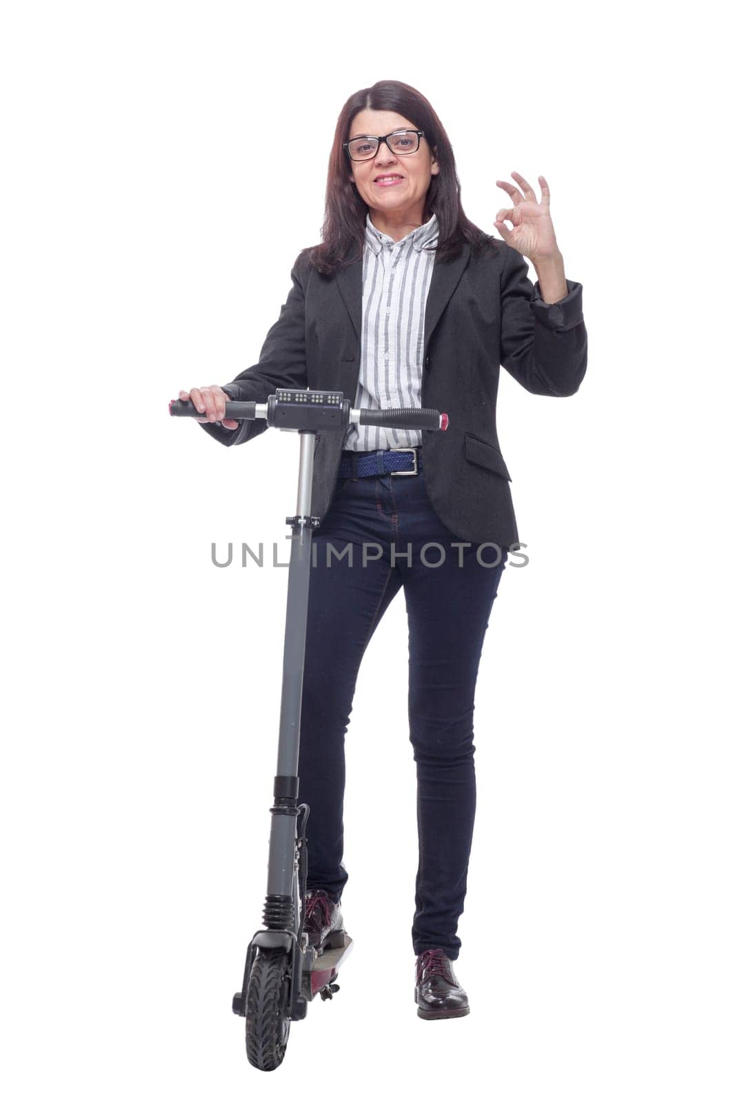 Happy beautiful woman standing near kick scooter and smiling at camera