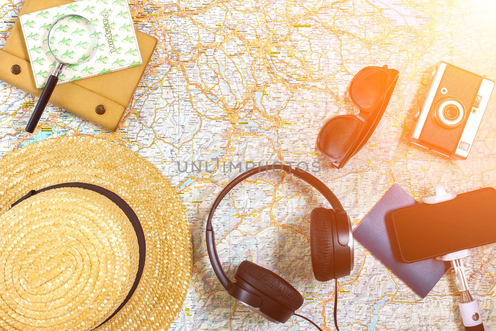 Travel plan, trip vacation accessories for trip, tourism mockup - Outfit of traveler on map background. Flat lay and copyspace. Still life. Sun flare