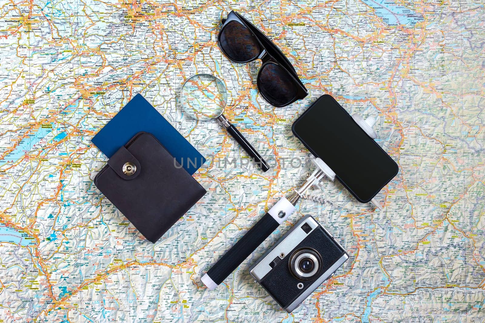 Travel accessories set on white background: smart, passport, map, camera and sunglasses. Top view point. Flat lay. Still life. Copy spase