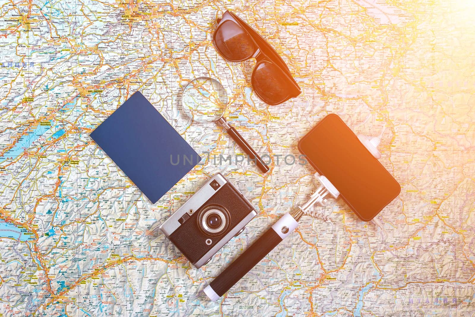 Travel plan, trip vacation accessories for trip, tourism mockup - Outfit of traveler on map background. Flat lay and copyspace. Still life. Sun flare
