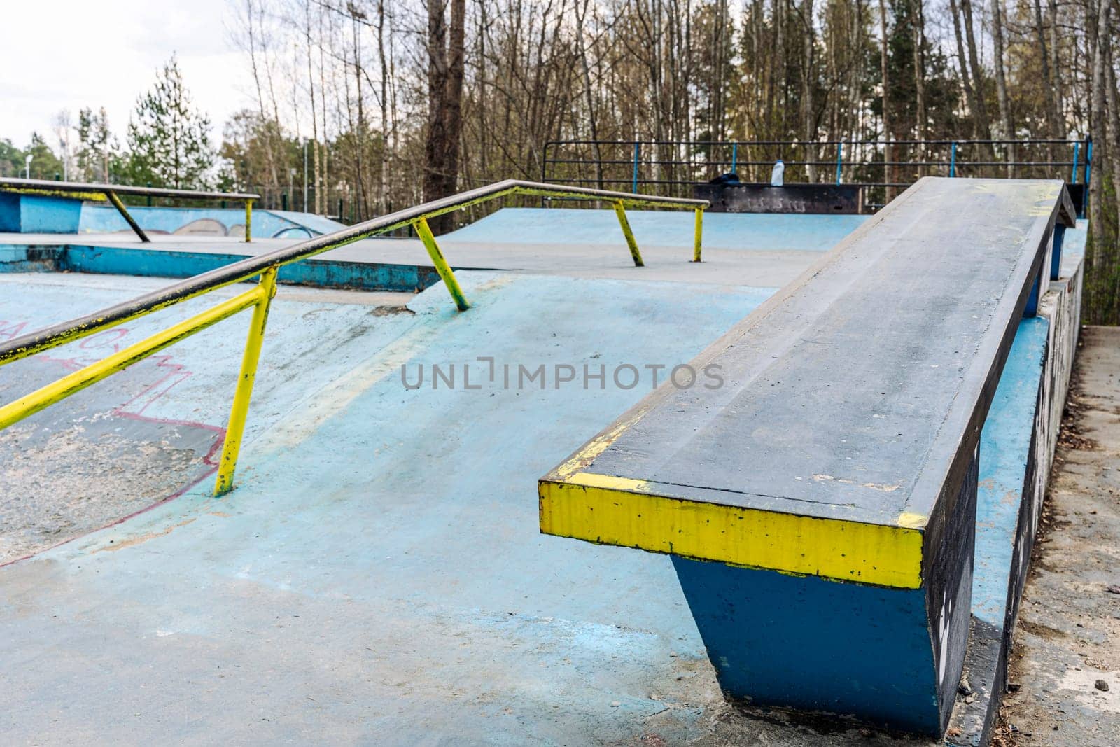 a ramp with an iron ramp for jumping in a skate park by audiznam2609