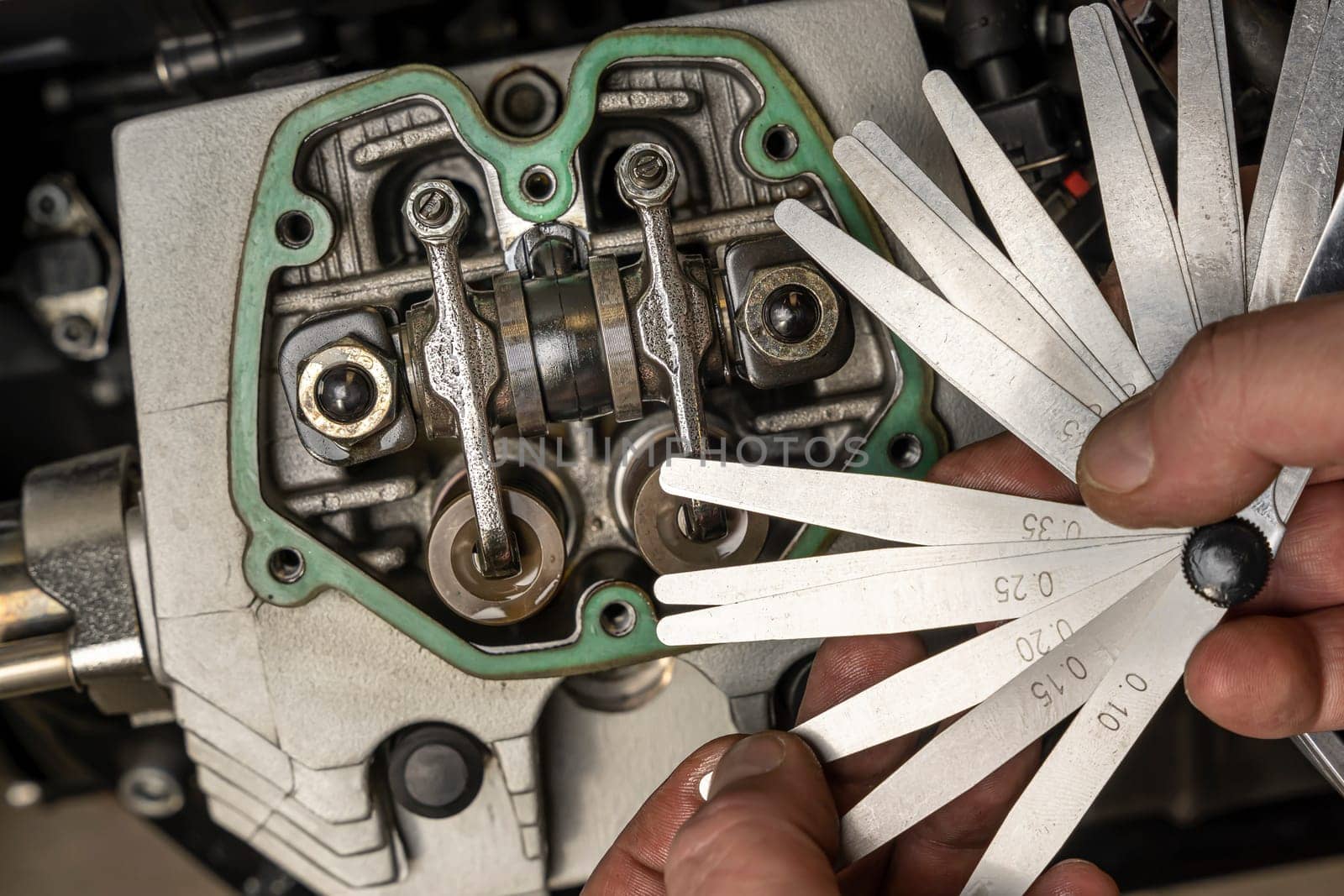 selection of the thickness of the probe for measuring and adjusting valve clearances in the motorcycle engine. Settings of the mechanism using measuring probes. garage or workshop maintenance