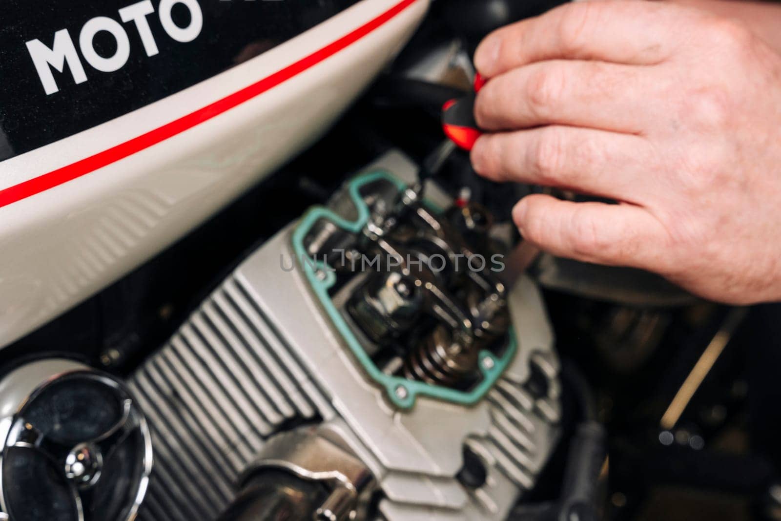 adjustment of gaps of valves in the motorcycle engine. Mechanism settings. Springs and adjusting screw of gaps of valves, dipstick. garage service or at the workshop. adjusting engine valves of motorcycle at the workshop