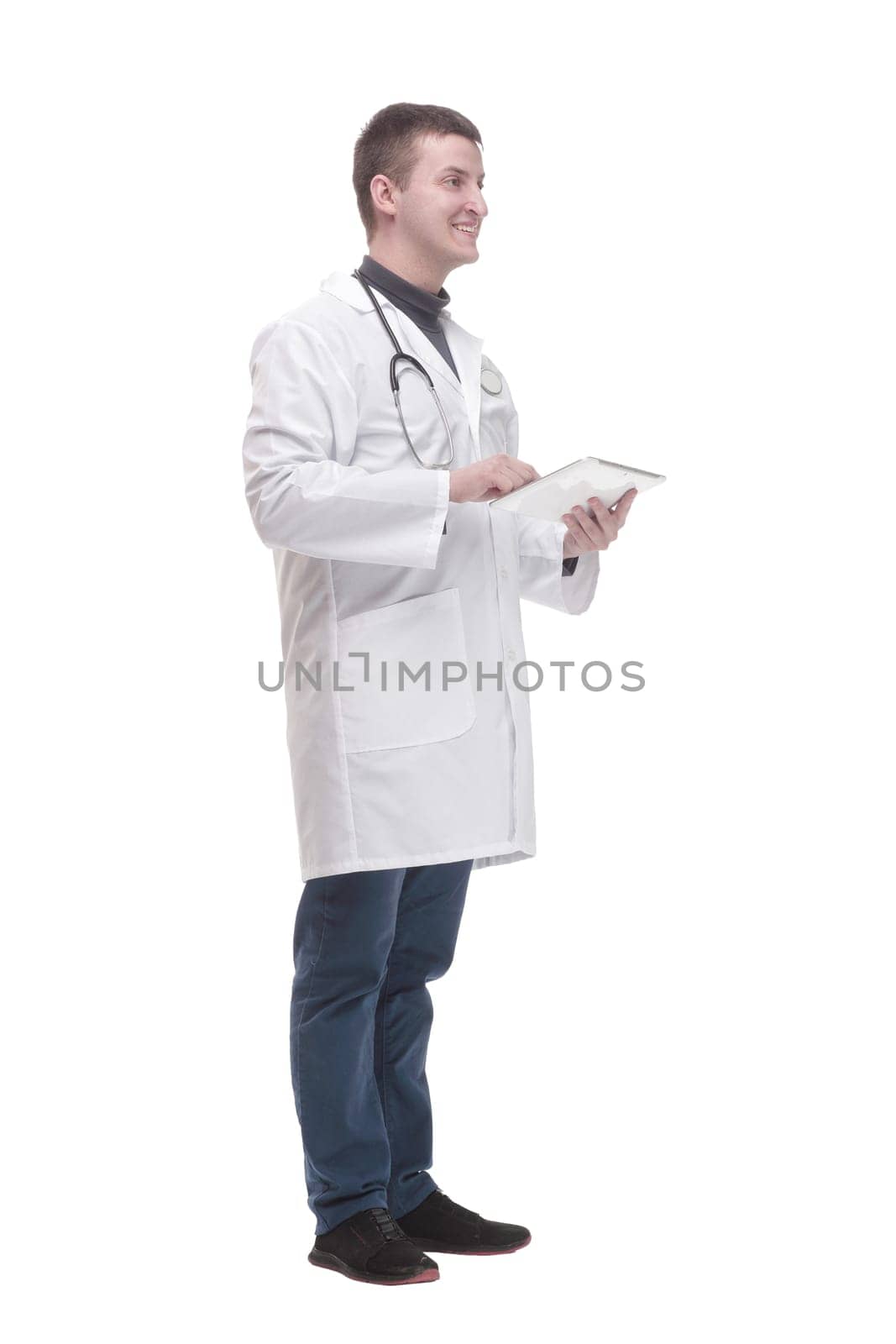 in full growth. modern doctor with a digital tablet. isolated on a white background.