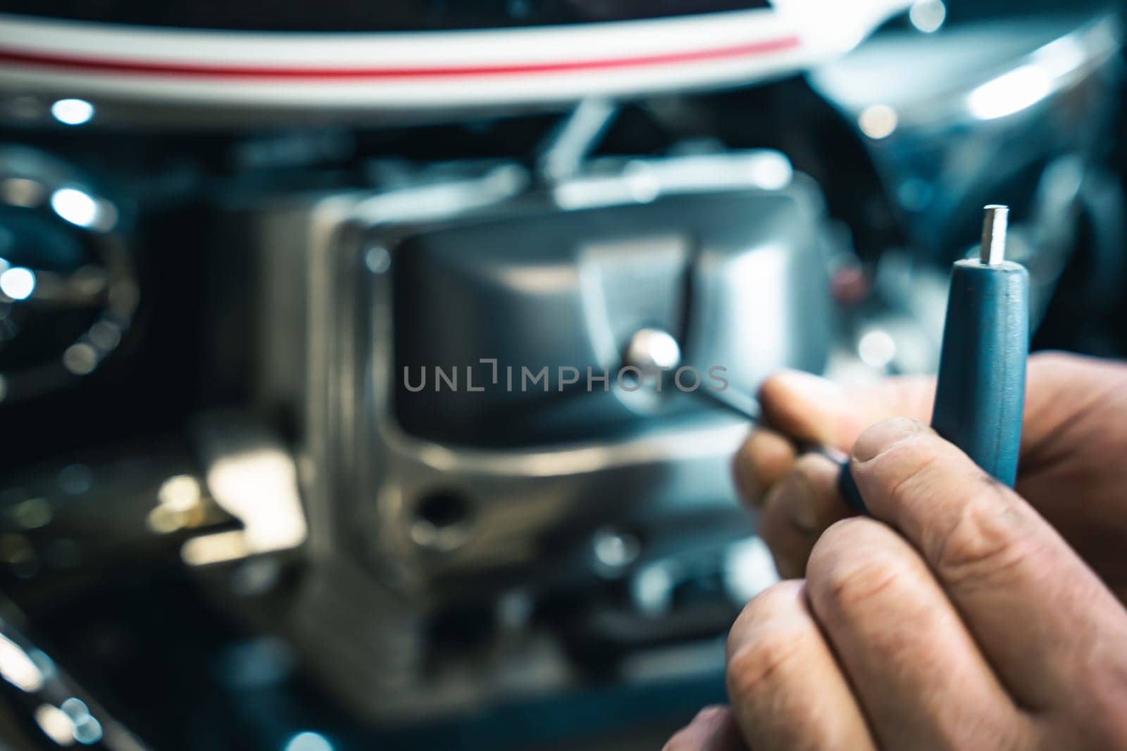installing the valve cover on the motorcycle engine. The mechanic installs and screws the valve cover. maintenance of motor vehicles. motorcycle repair and maintenance concept.defocus, blur