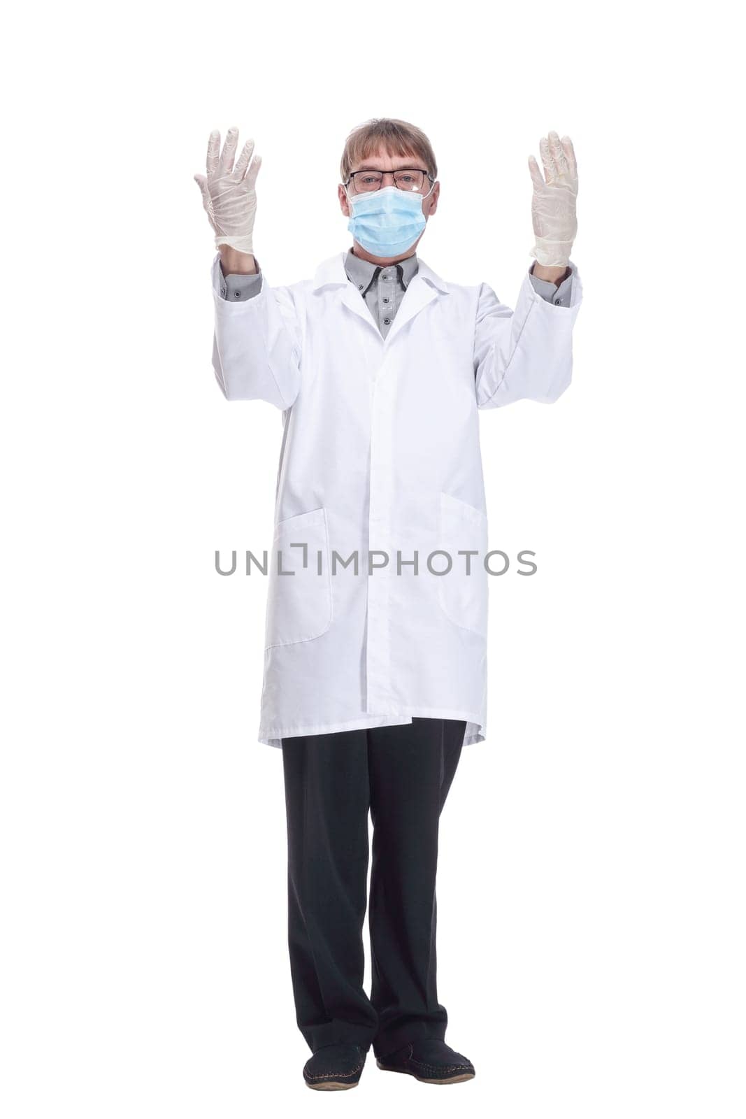 in full growth. doctor in protective mask showing thumbs up. isolated on a white background.