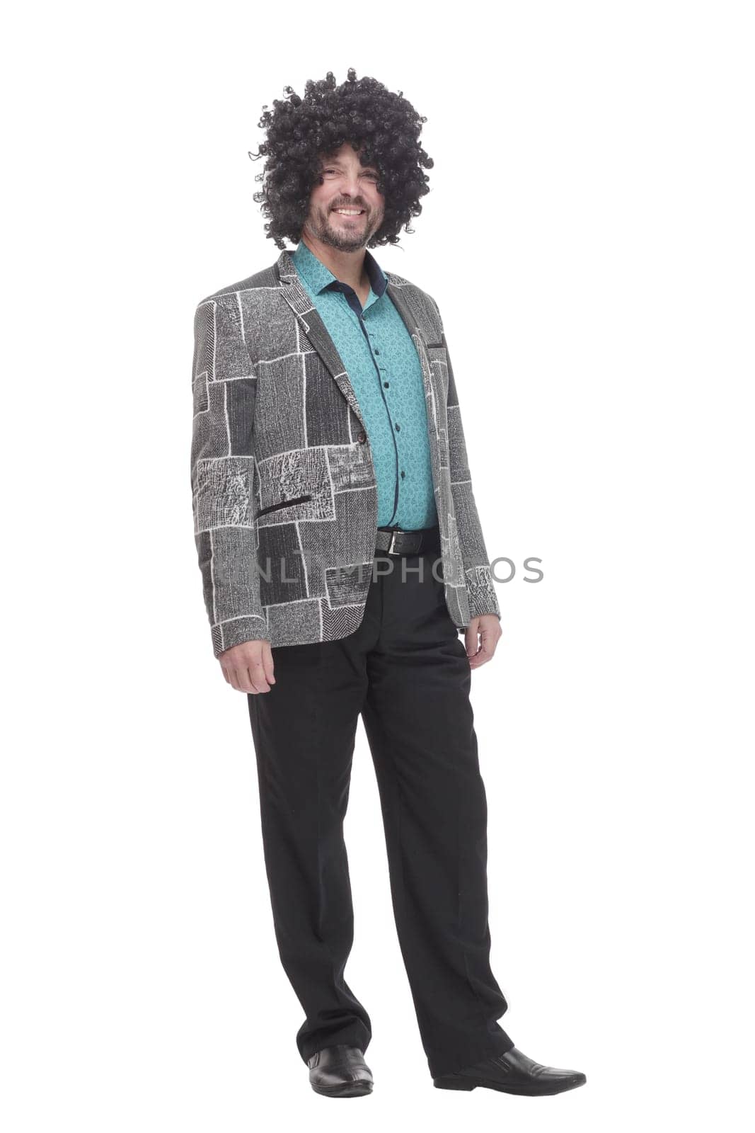 in full growth. cheerful man in a curly wig. isolated on a white background.