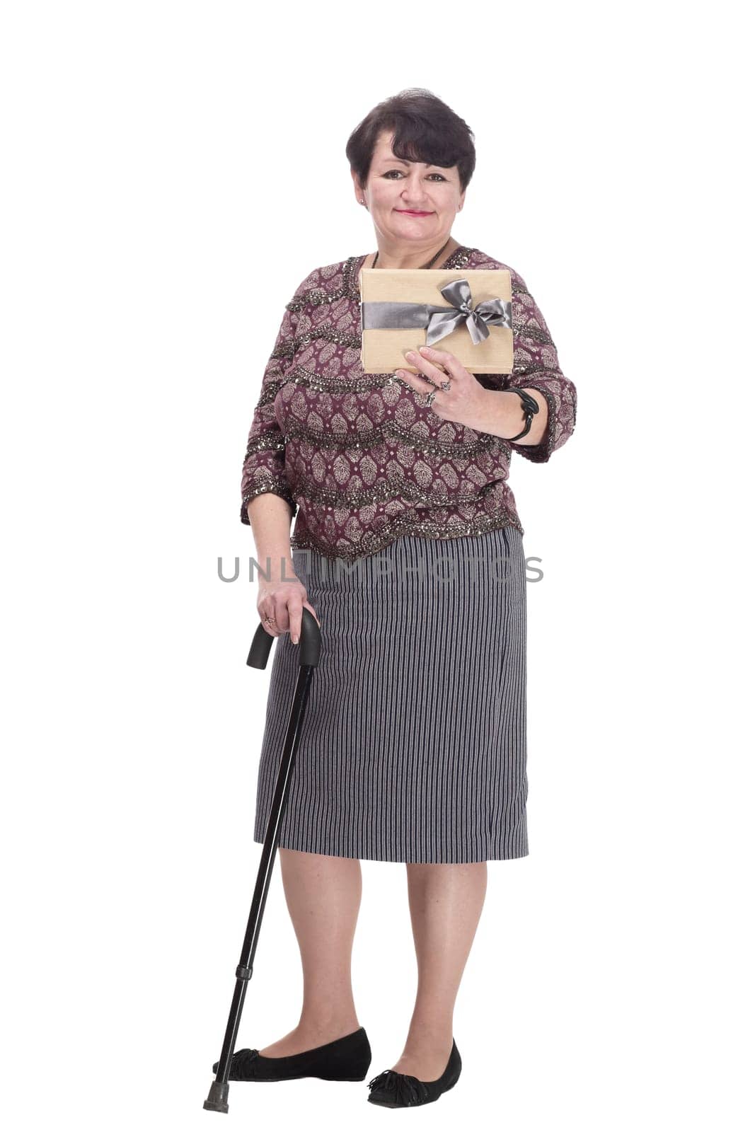 in full growth. elderly woman with a gift box. isolated on a white background.